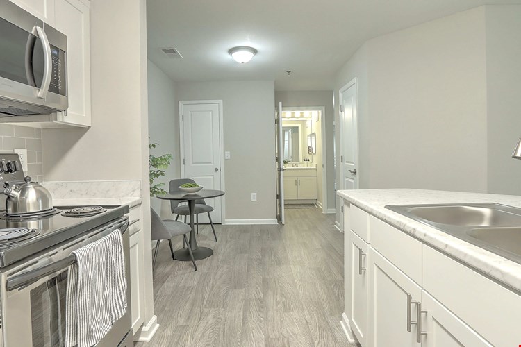 Relish an elegant dining area adjacent to your well-equipped kitchen with an extra storage closet for maximum convenience.