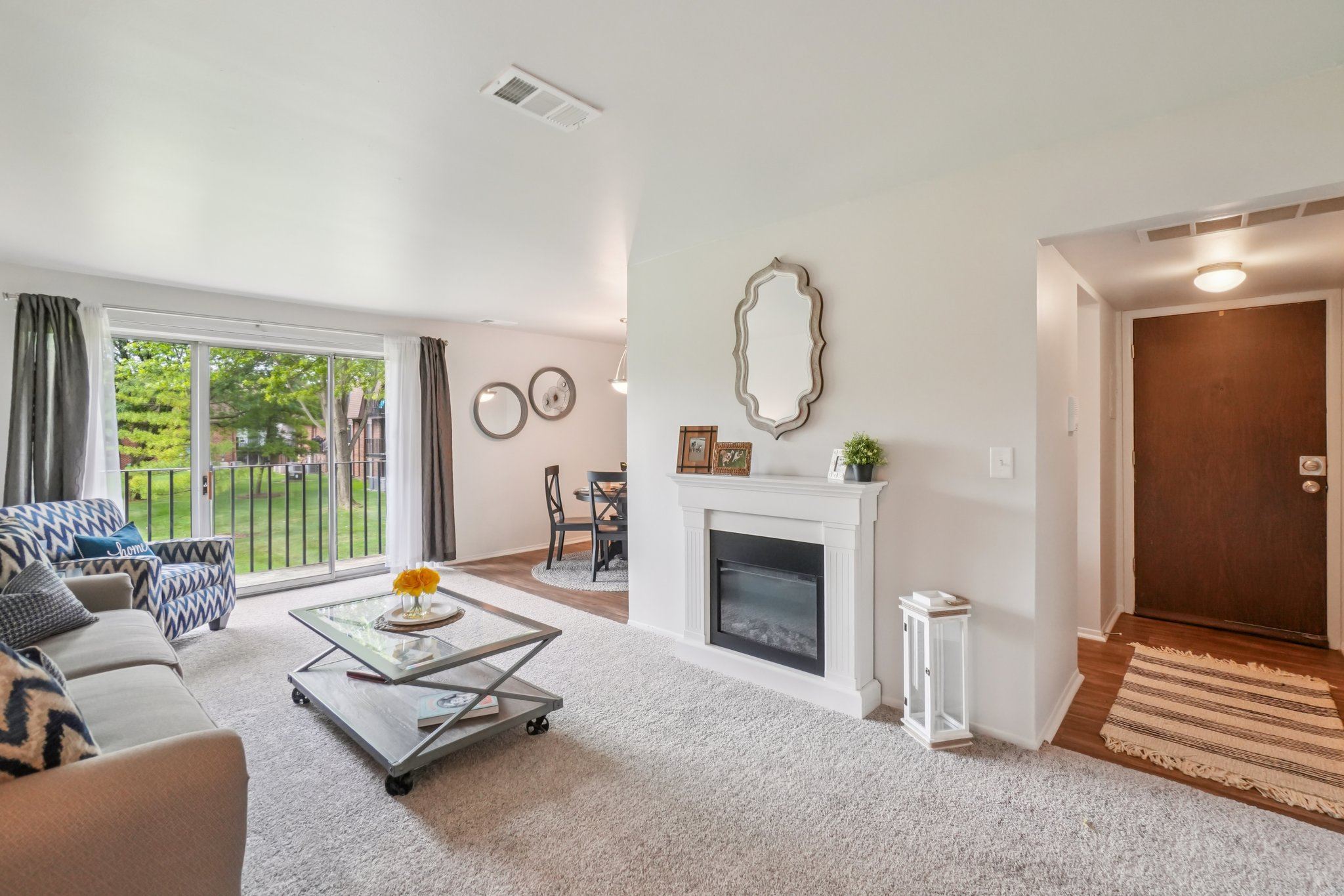 Elevated living room and private patio or balcony at Drawbridge Apartments in Harrison Township, MI.