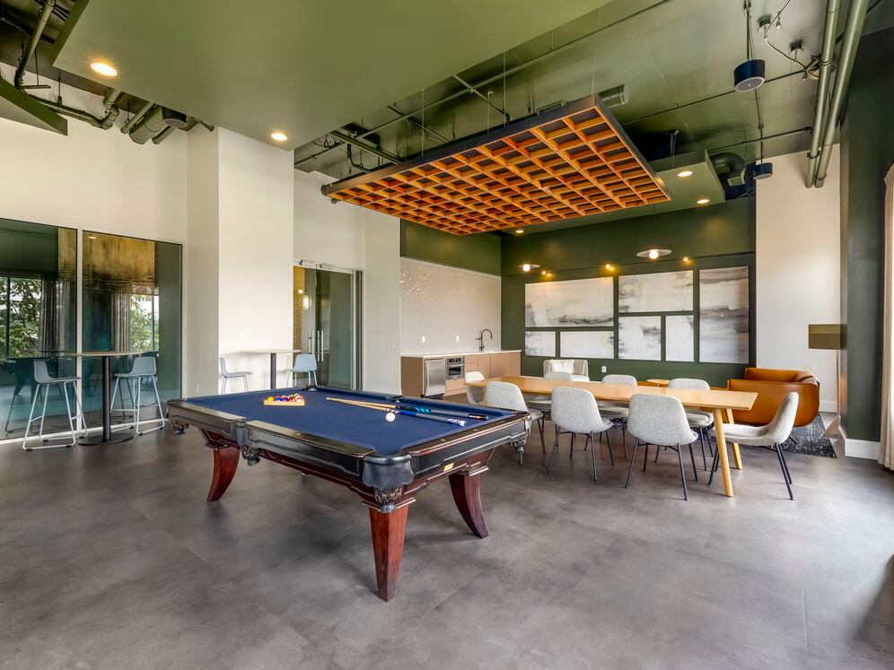 Resident lounge with pool table and coworking spaces