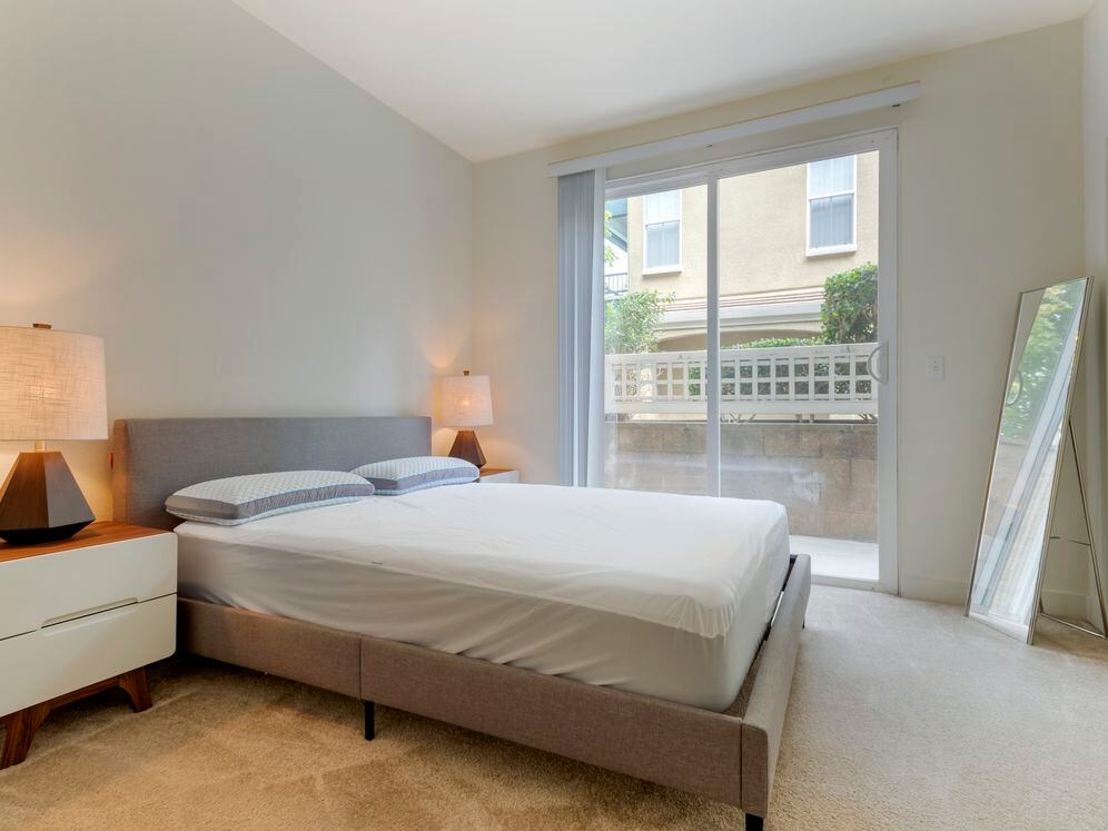 Furnished+ apartment homes feature queen bed with mattress, two pillows, dresser, nightstands, lamp, and mirror. (Representative Image – exact items and style of furnishings may vary)