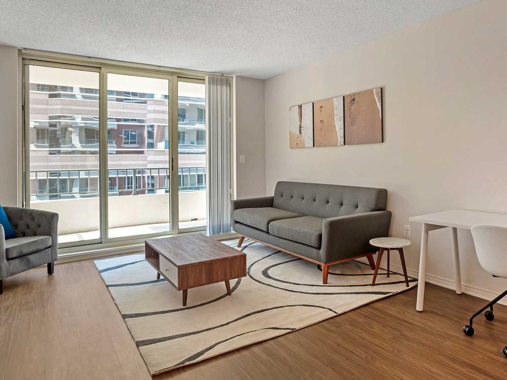 Furnished+ apartment homes come outfitted with a sofa, side chair, side table, coffee table, TV stand and 50" Television (Representative Image – exact items and style of furnishings may vary)