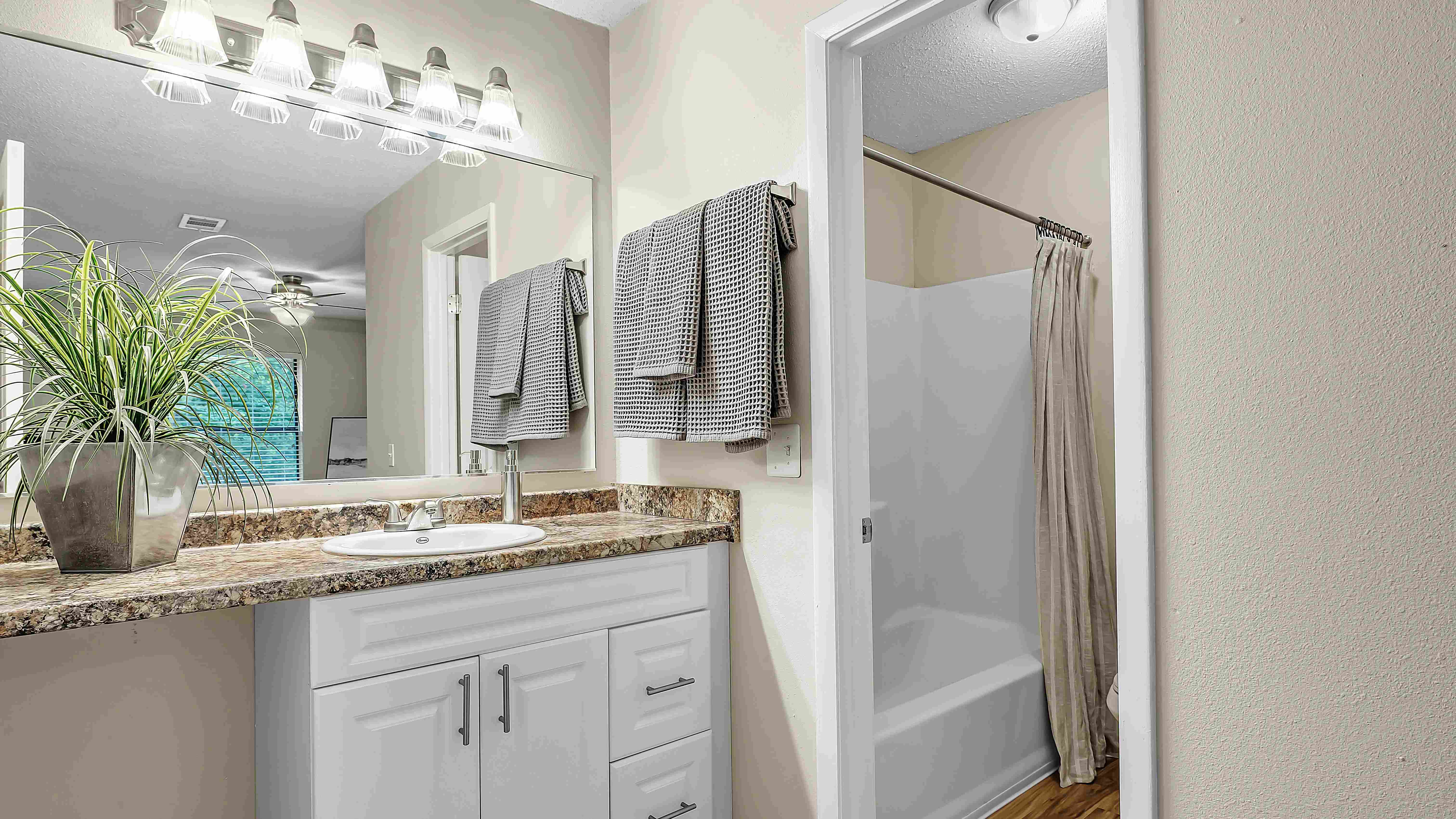 Rejoice in opulence within the master bathrooms featuring distinct vanity and shower spaces for a regal, spa-like retreat. 