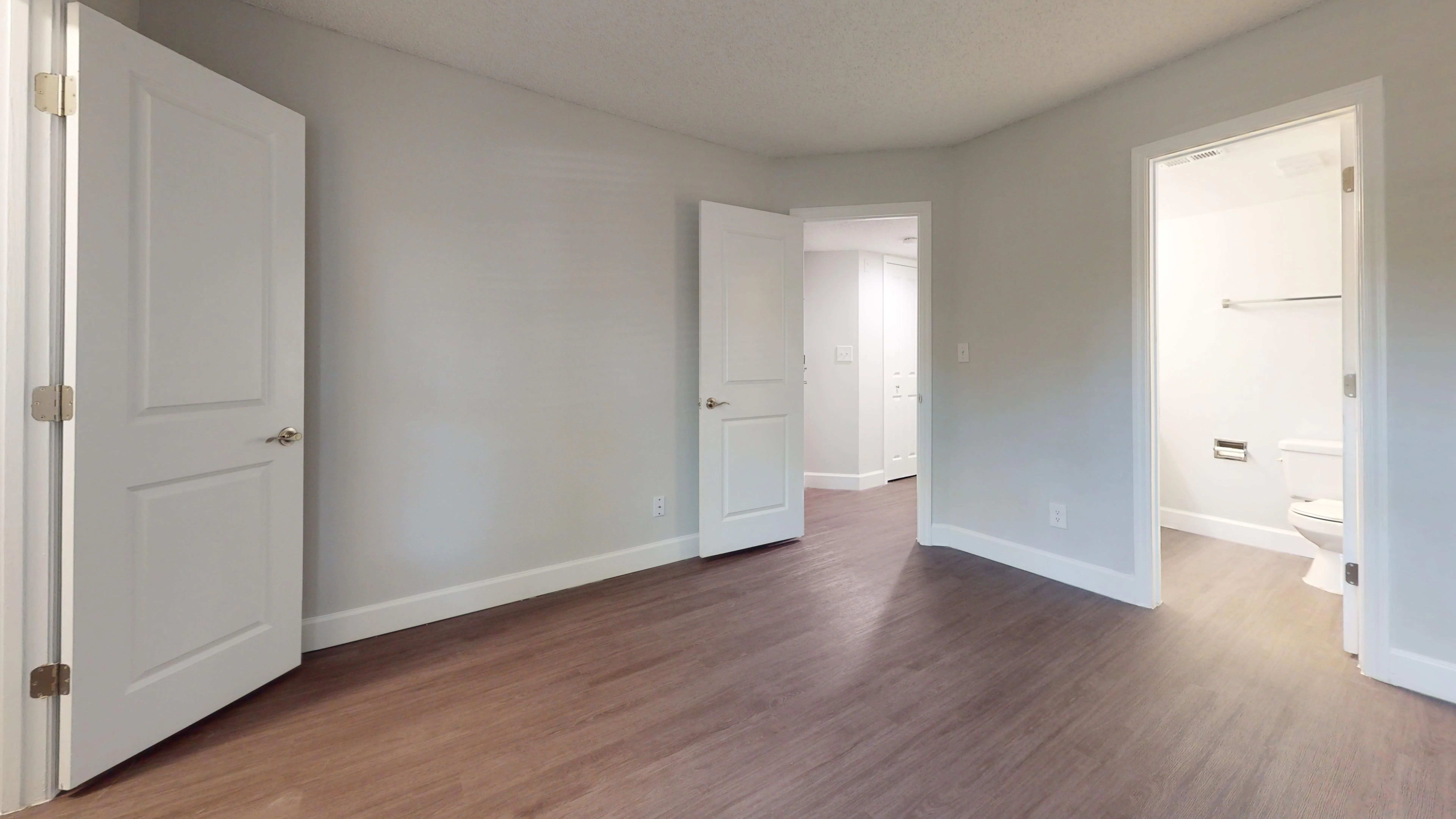 The Martinique floor plan features a spacious master bedroom with direct access to a private ensuite bath, modern flooring, and ample closet space.