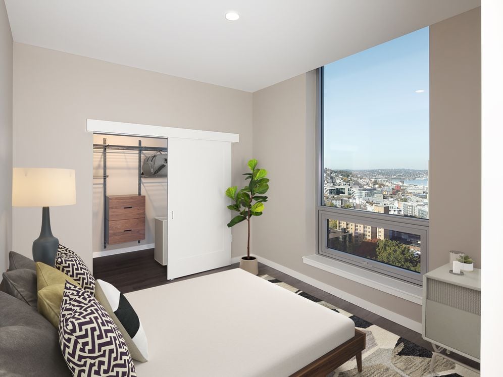 Signature Collection penthouse bedroom with floor-to-ceiling windows and hard surface flooring.