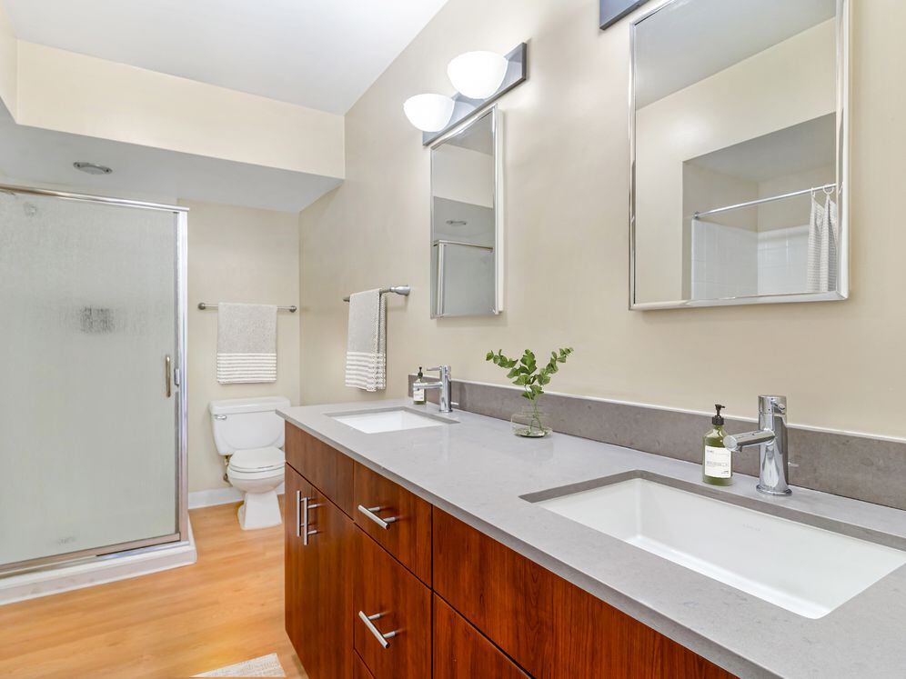 Bath with espresso cabinetry, grey quartz countertops, and hard surface flooring
