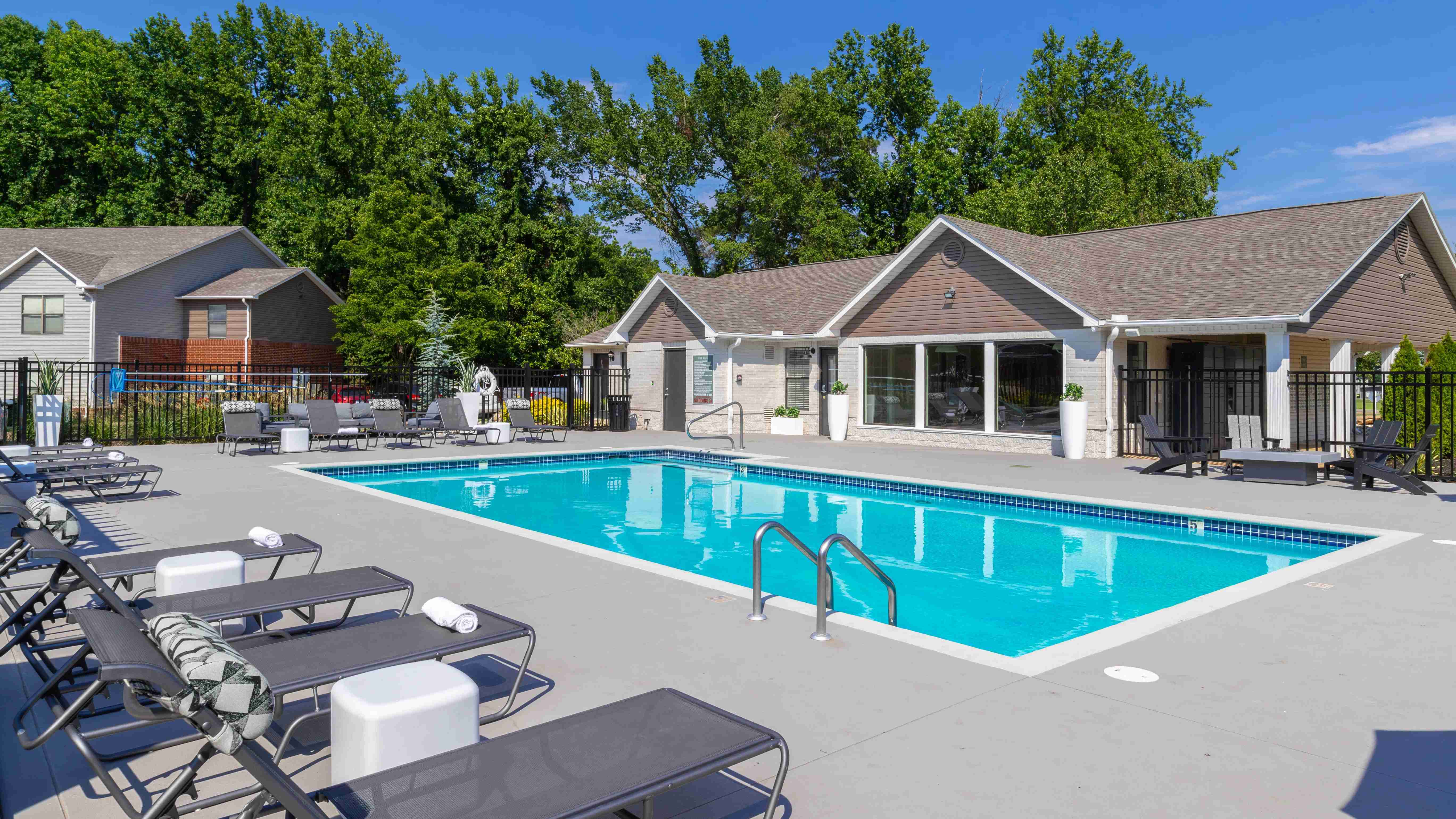 Discover a serene poolside retreat at our tranquil poolside lounge, featuring comfortable seating and lush surroundings.