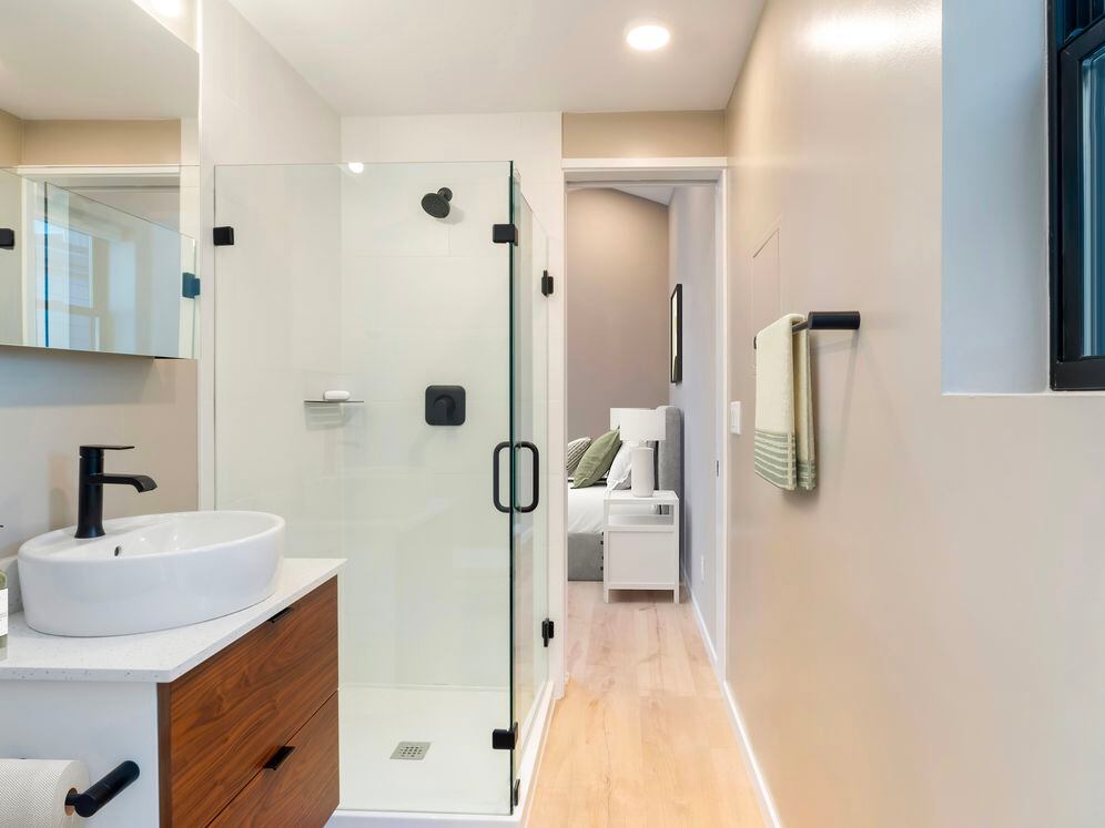 Freestanding home bath with white quartz countertops and hard surface flooring