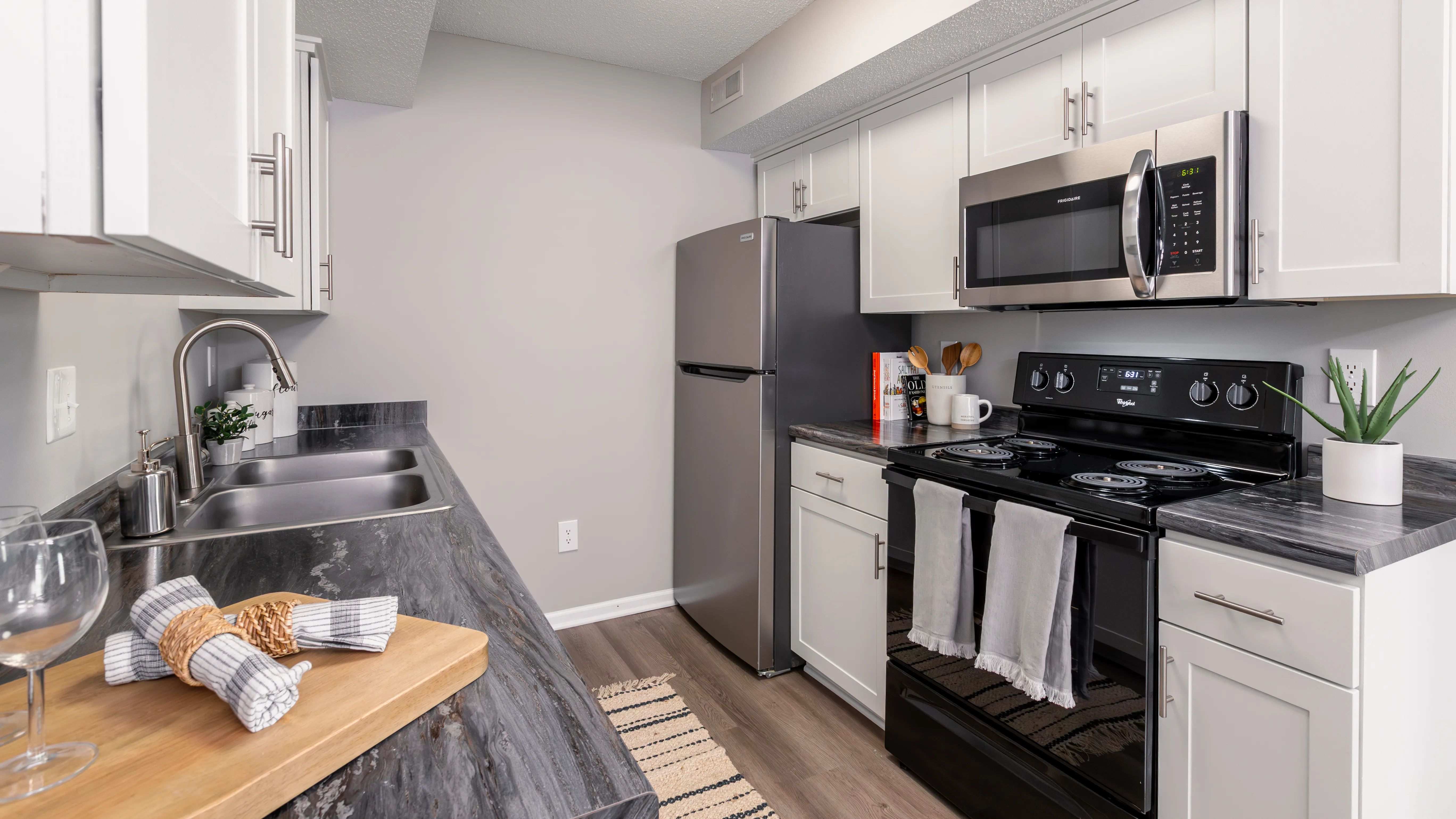 This stylish kitchen features modern stainless steel appliances, sleek countertops, and ample storage space, making it perfect for culinary enthusiasts.