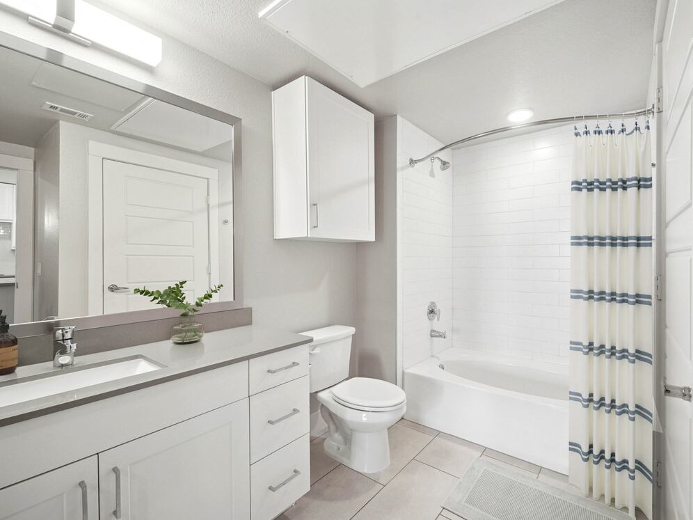 Finish Package II bath with grey quartz countertops and white cabinetry