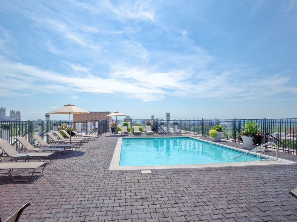 Rooftop swimming pool and sundeck with lounge seating