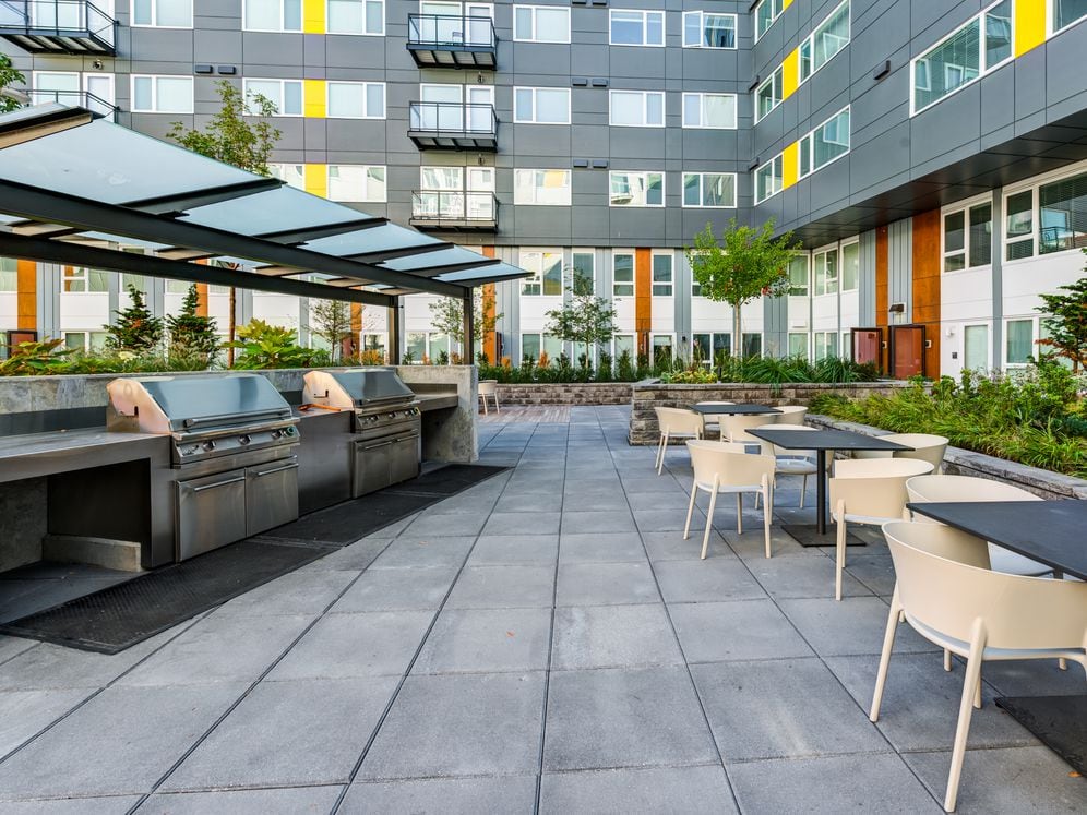 Outdoor lounge with barbecue grills and dining area