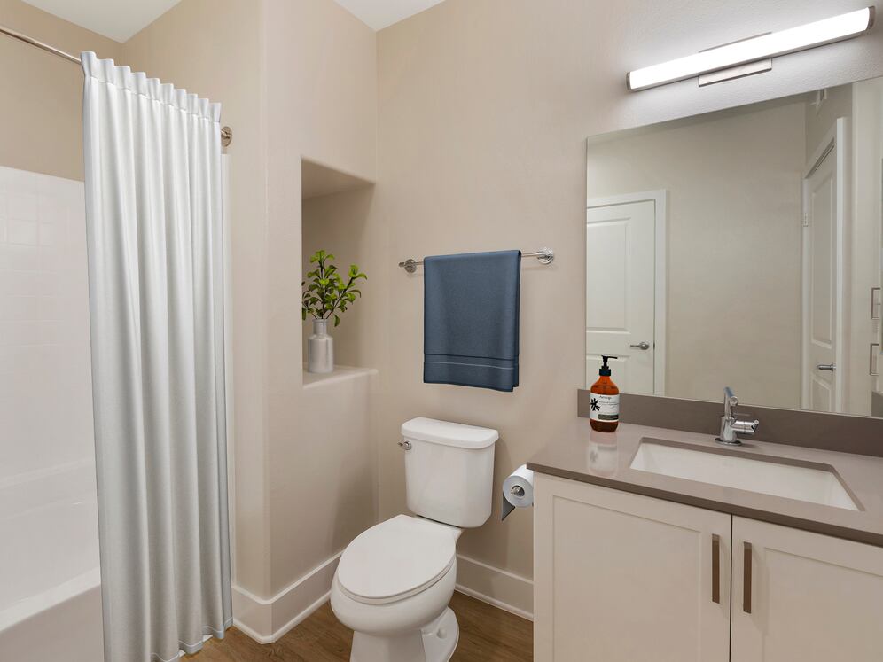 Renovated Package I bath with grey quartz countertops, white cabinetry, and hard surface flooring