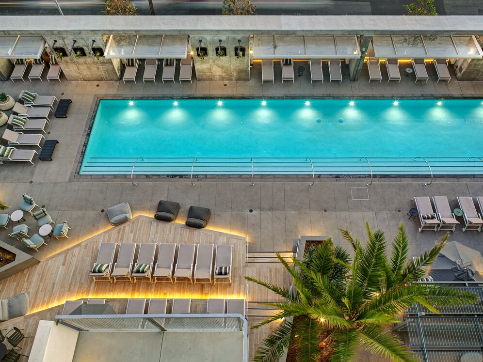 Pool and sundeck with cabanas and lounge seating