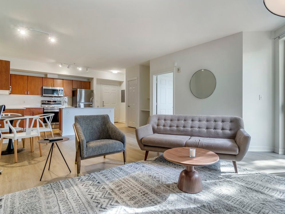 Furnished+ apartment homes come outfitted with a sofa, side chair, side table, coffee table, TV stand and 50" Television (Representative Image – exact items and style of furnishings may vary)