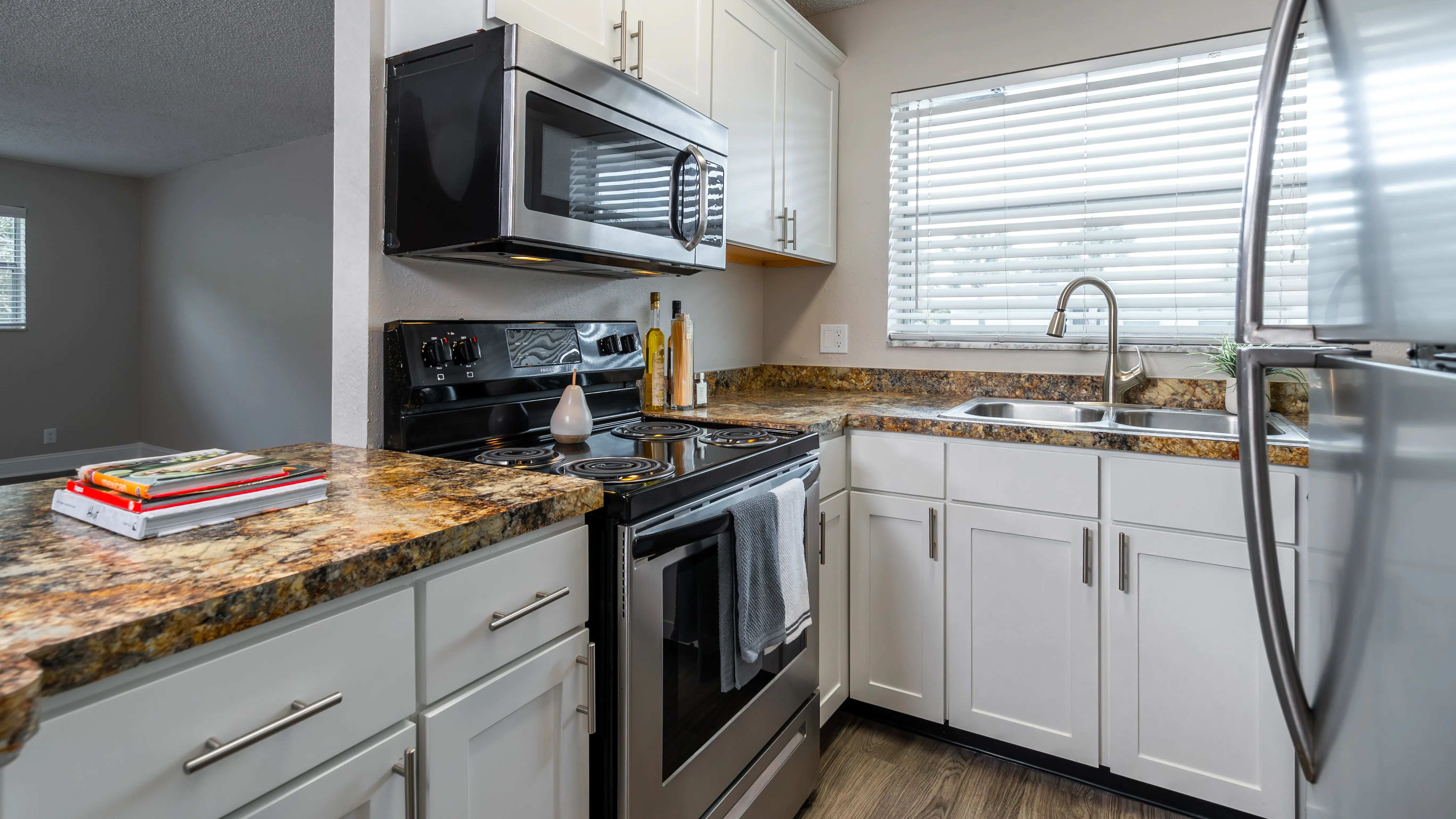 Relish in an open kitchen and sprawling granite-like countertops that transform into a delightful breakfast bar, perfect for prepping and enjoying home cooked meals.