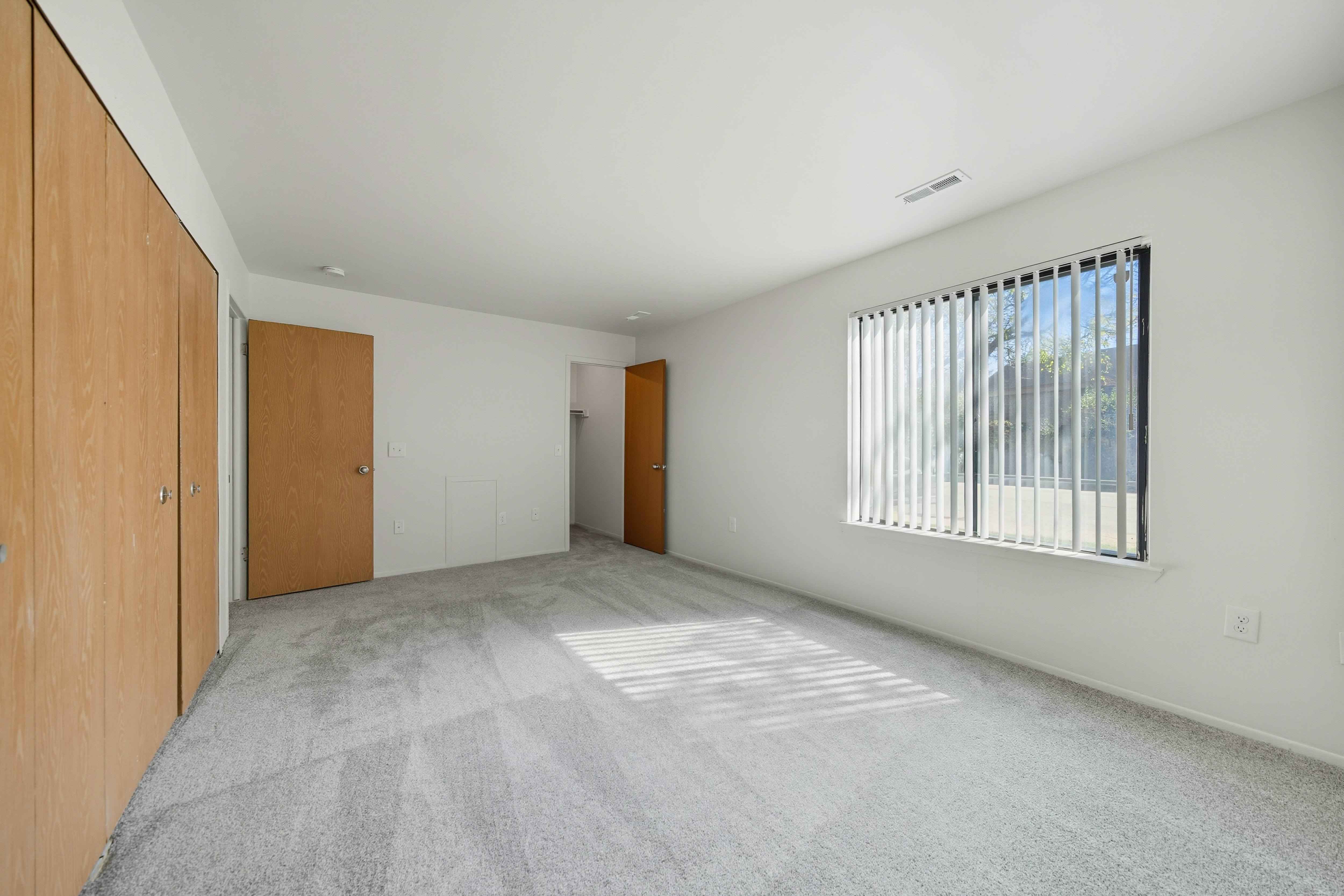 Large bedroom with natural light at Franklin River Apartments in Southfield, MIng Room with natural light at Franklin River Apartments in Southfield, MI