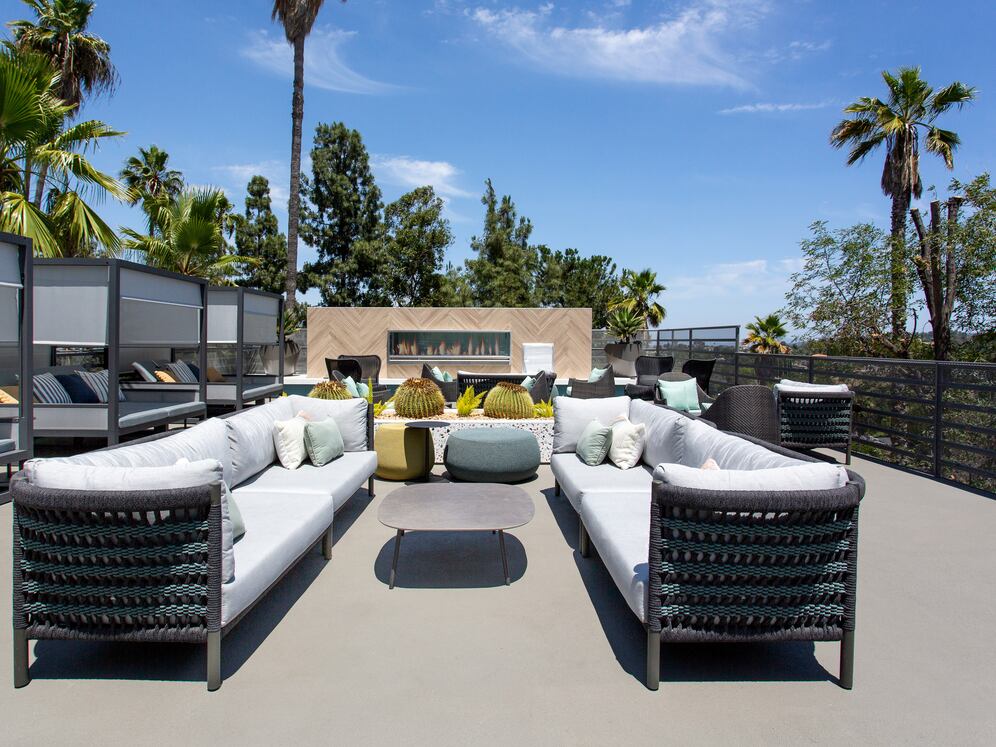 Outdoor lounge with cabanas and fireplace