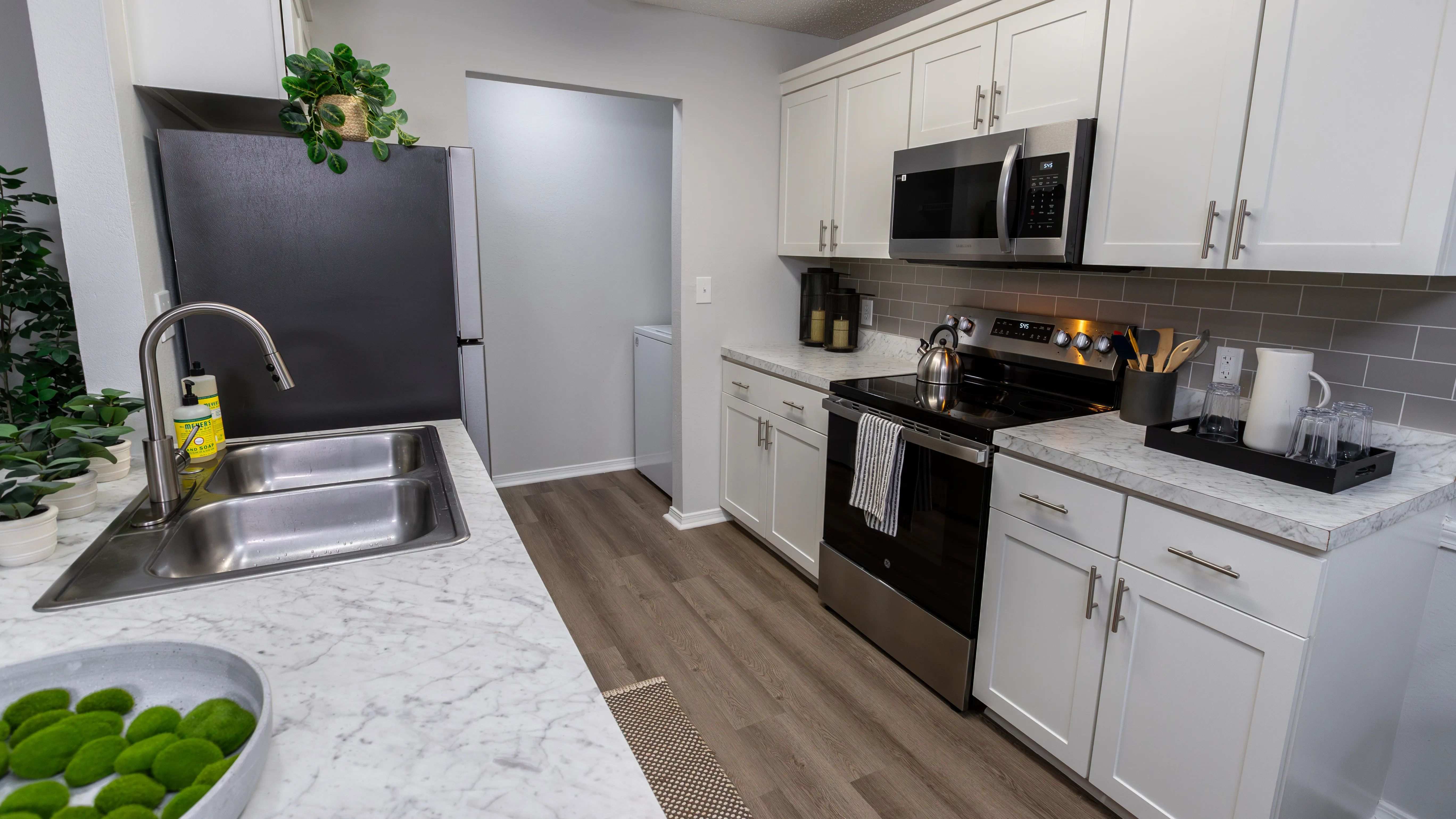Stylish kitchens offering a modern look with stainless steel appliances, marble countertops, and a functional layout.