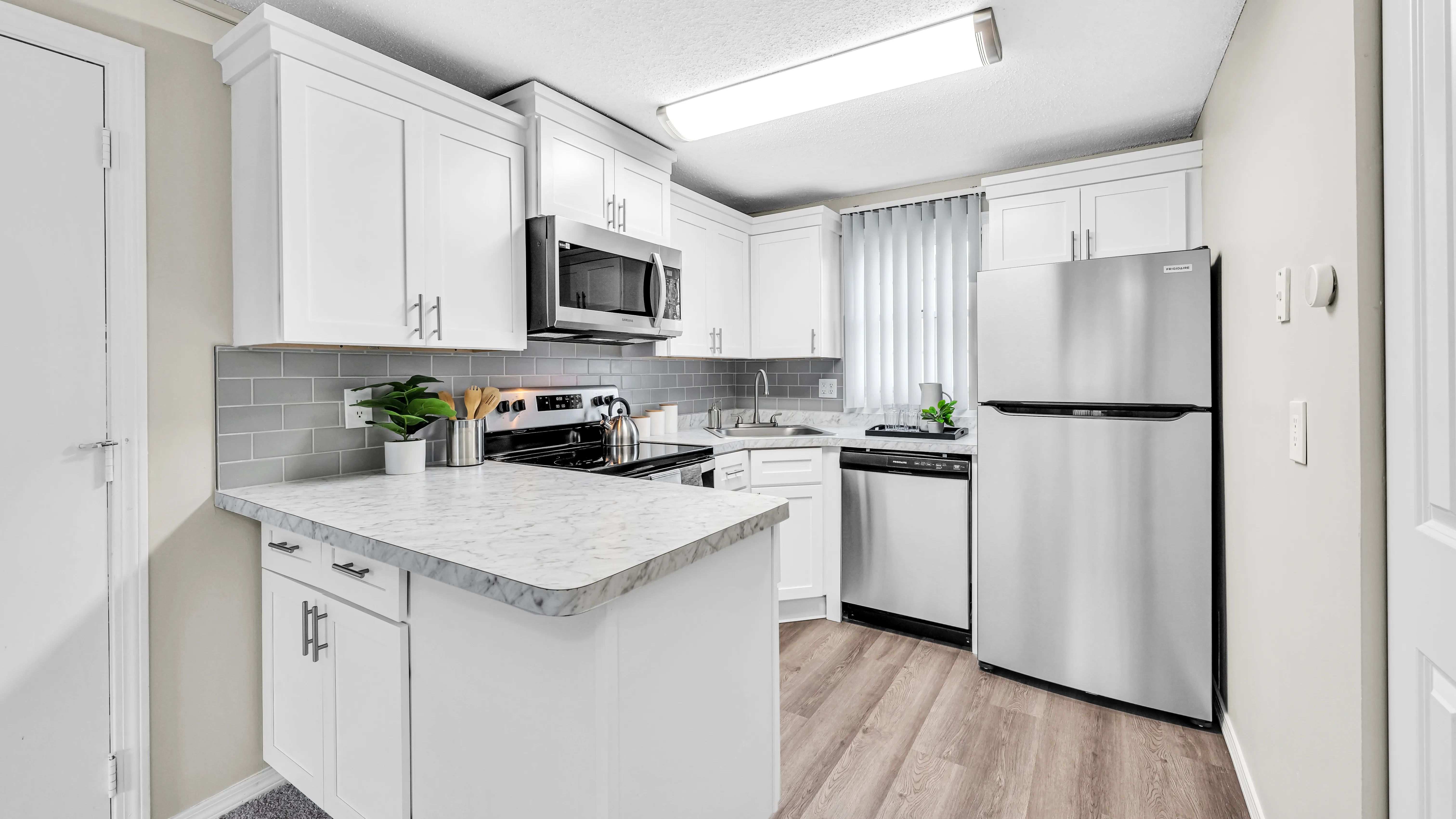 Cherish our stunning, renovated kitchens featuring Carrara-style countertops and wood-style flooring. 