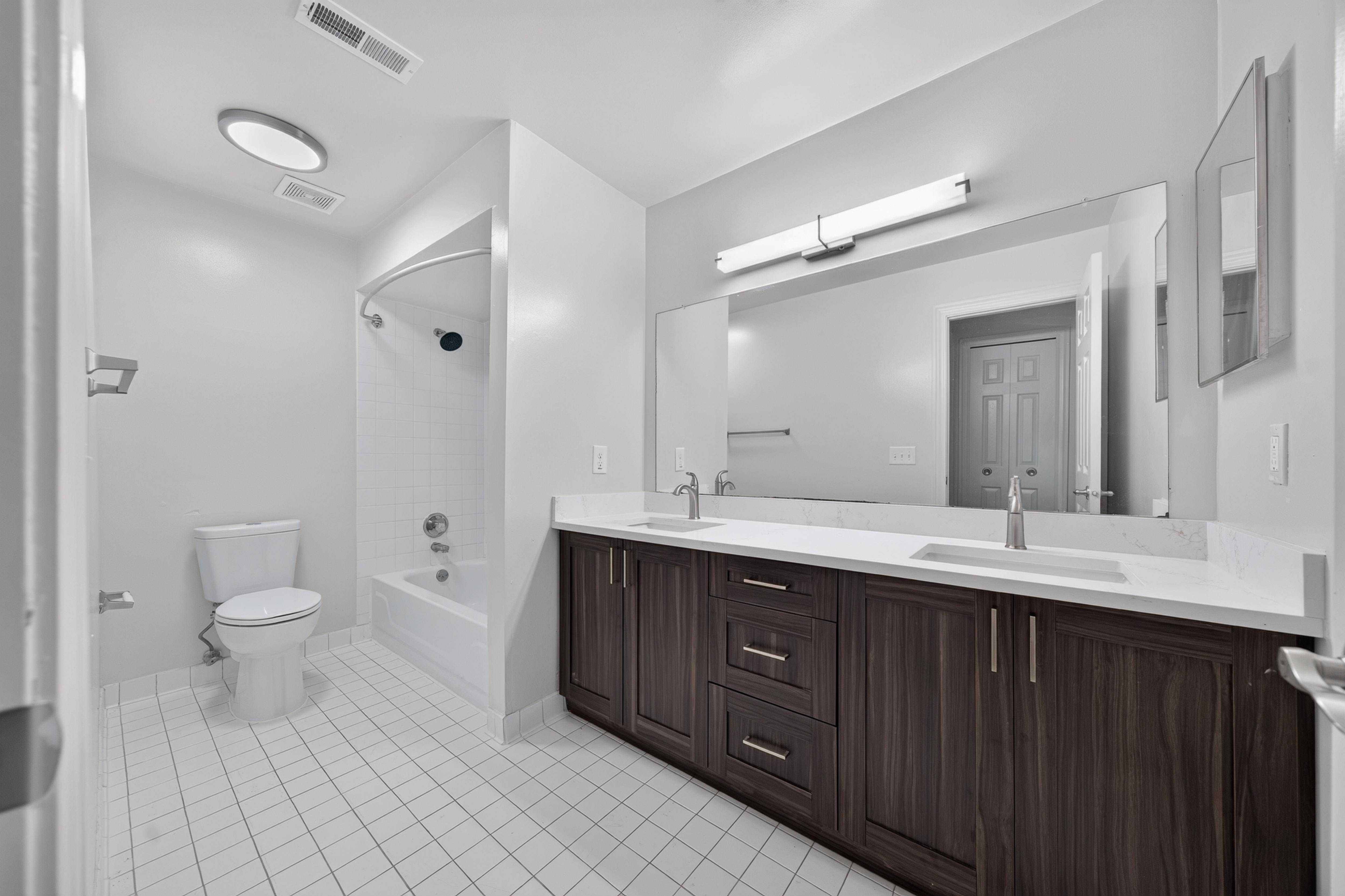 Modern bathroom with tub at Franklin River Apartments in Southfield, MI.