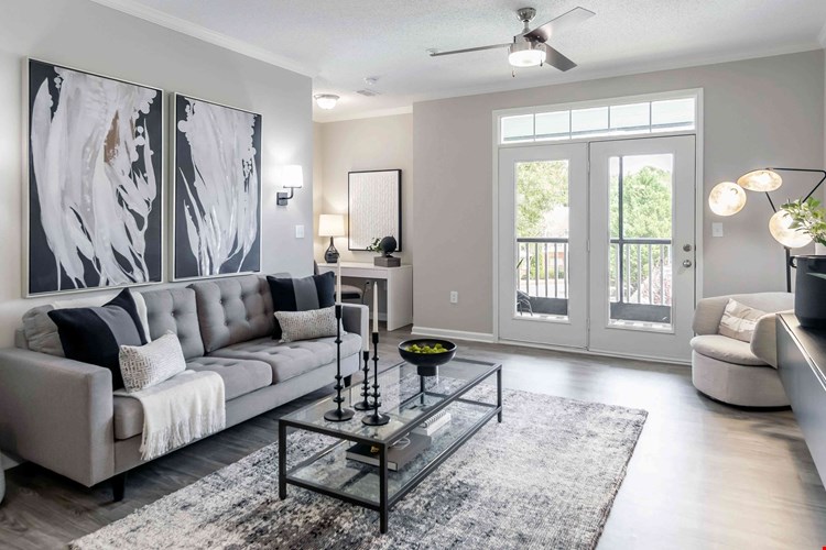 Embrace the best of both worlds in our spacious living room with access to a serene, screened patio. (In select units)