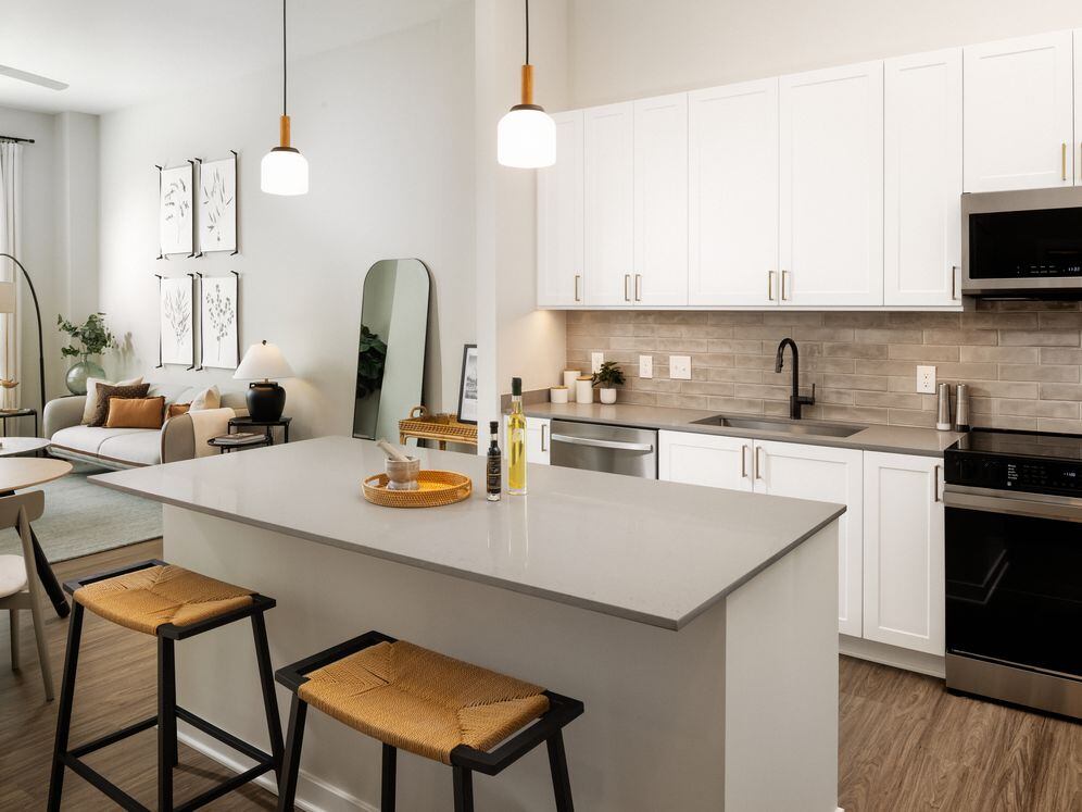 Design Collection I kitchen with stainless steel appliances, grey quartz countertops, white cabinetry, and hard surface flooring