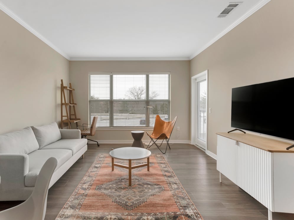 Furnished+ apartment homes come outfitted with a sofa, side chair, side table, coffee table, TV stand and 50" Television (Representative Image – exact items and style of furnishings may vary)