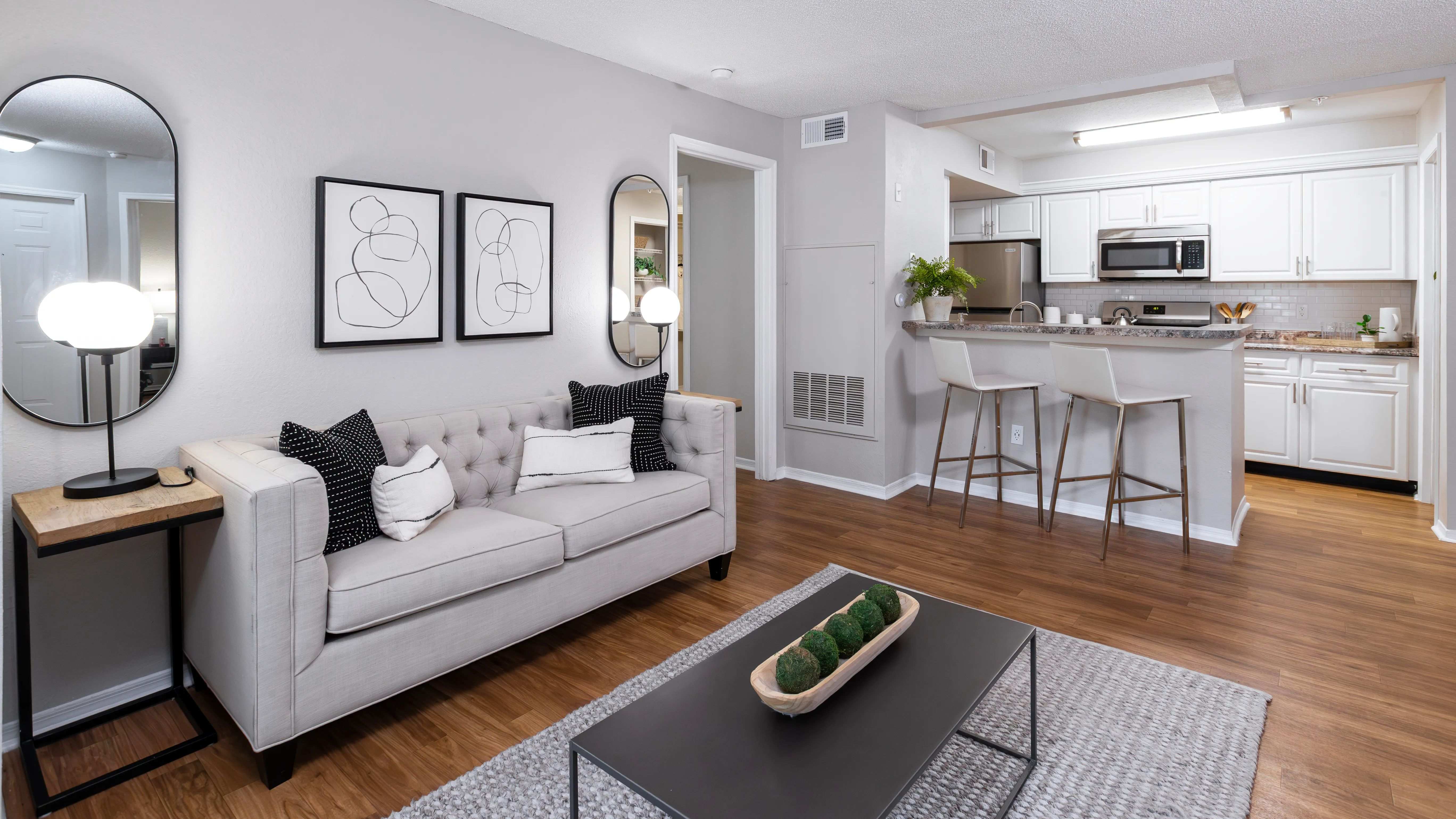 Enjoy the inviting feel of this open-concept living area featuring wood-style flooring, modern finishes, and a seamless flow into the kitchen—perfect for hosting or relaxing.