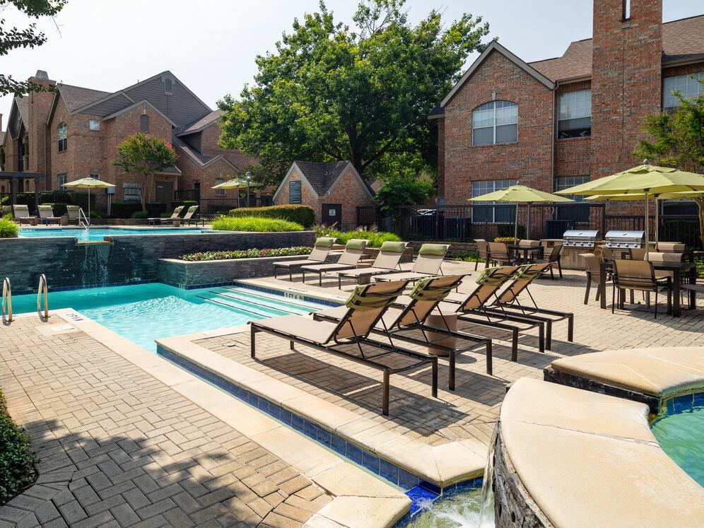 Swimming pool and sundeck with picnic tables