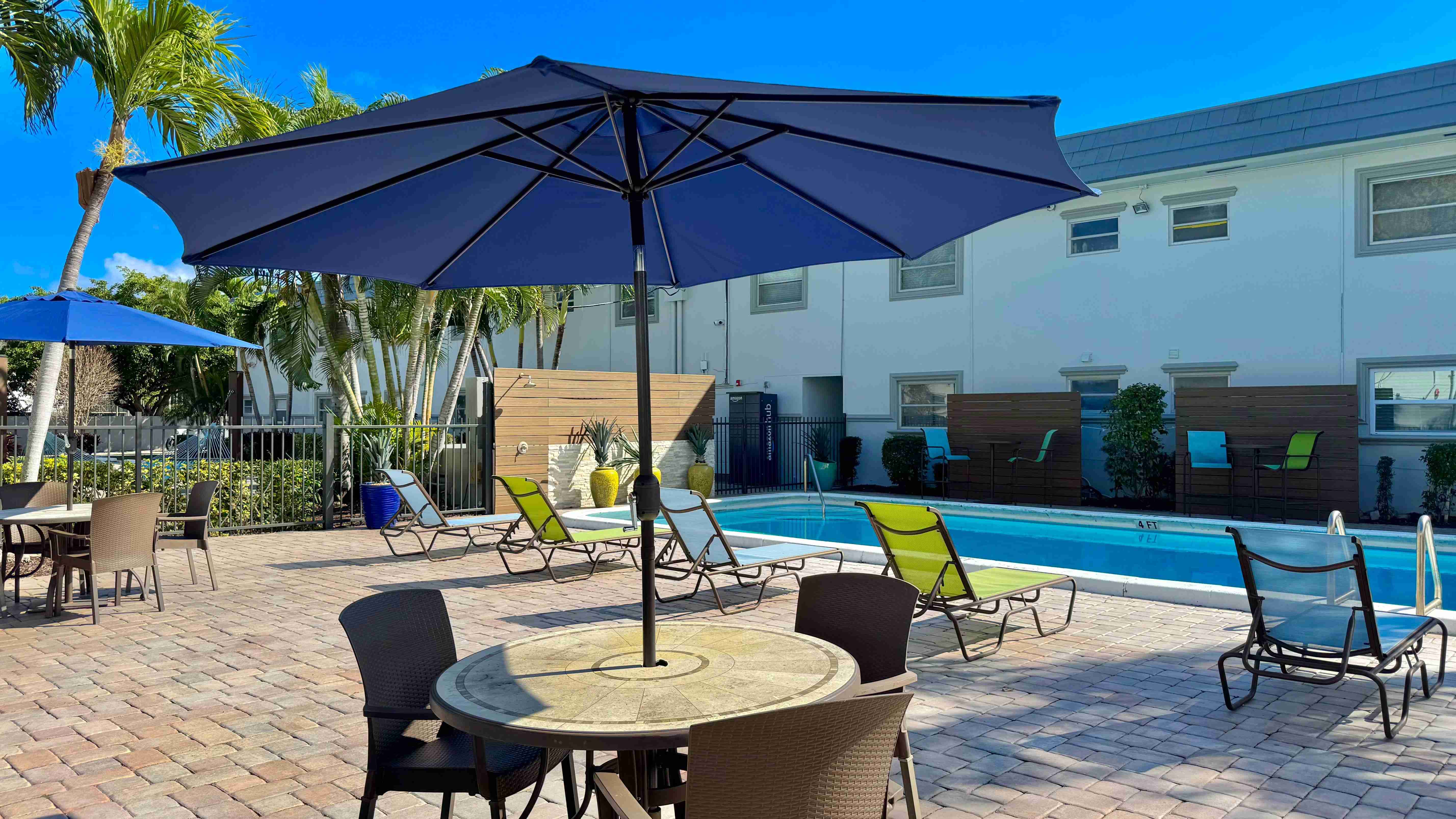 Enjoy poolside dining under the shade, with a serene atmosphere.