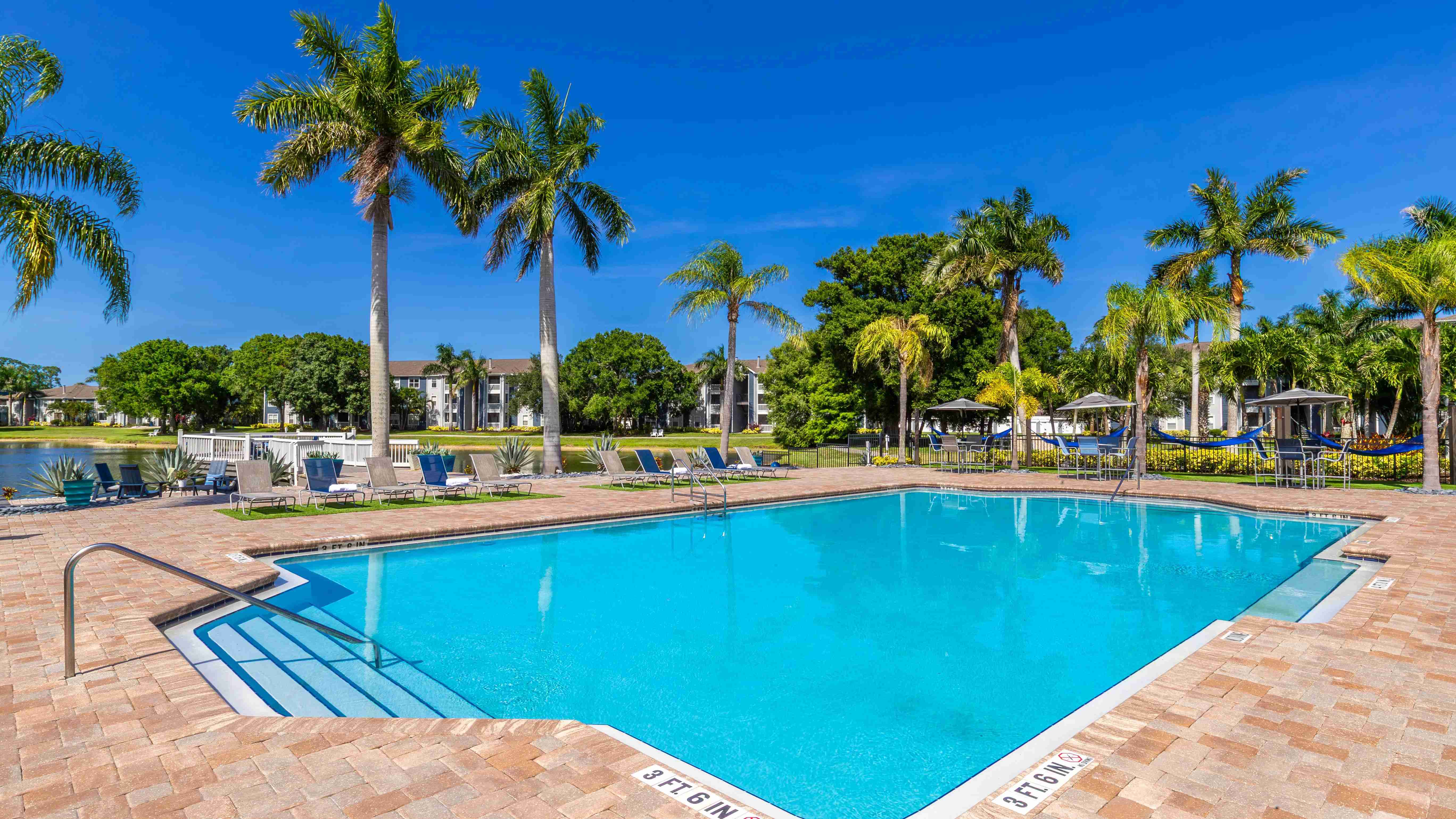 Bask under the Florida sun at our sparkling resort-style pool, surrounded by swaying palms, comfortable loungers, and breathtaking lake views.