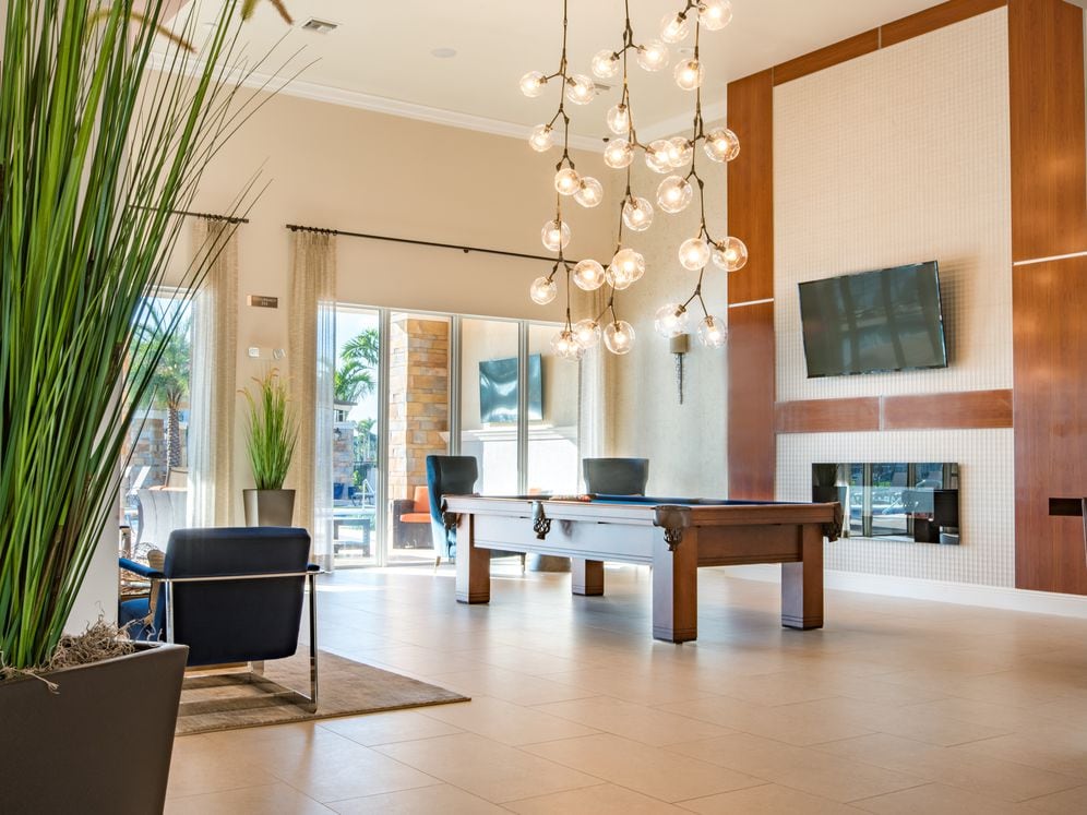 Resident lounge with TV, billiards, and fireplace