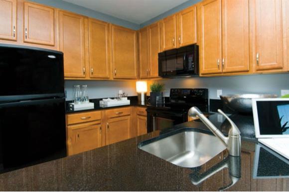 Large kitchens with premium 42" maple cabinetry, sleek black appliances and granite countertops
