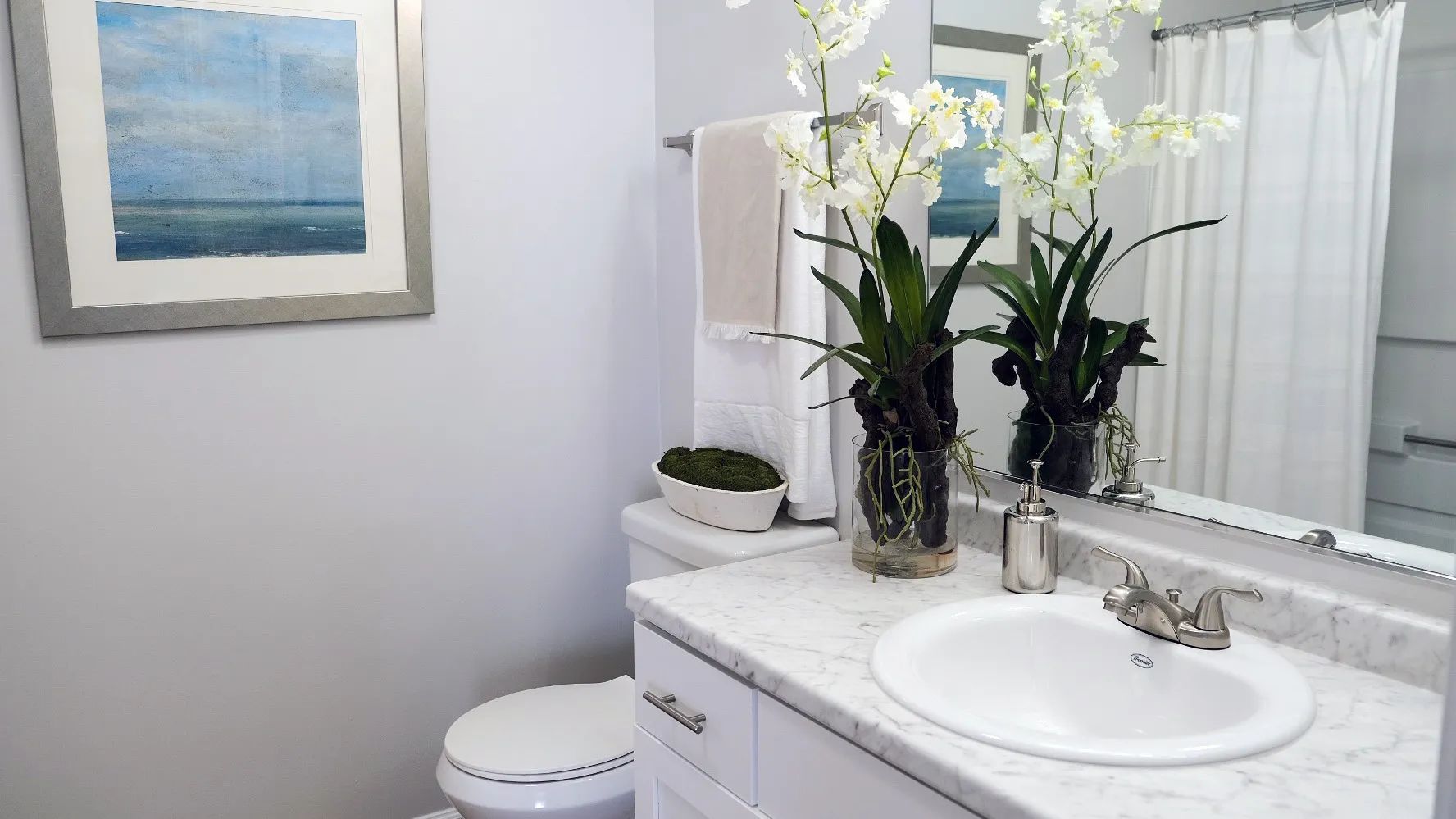Indulge in modern, upscale living with our Carrara marble-inspired countertop and expansive mirrors.