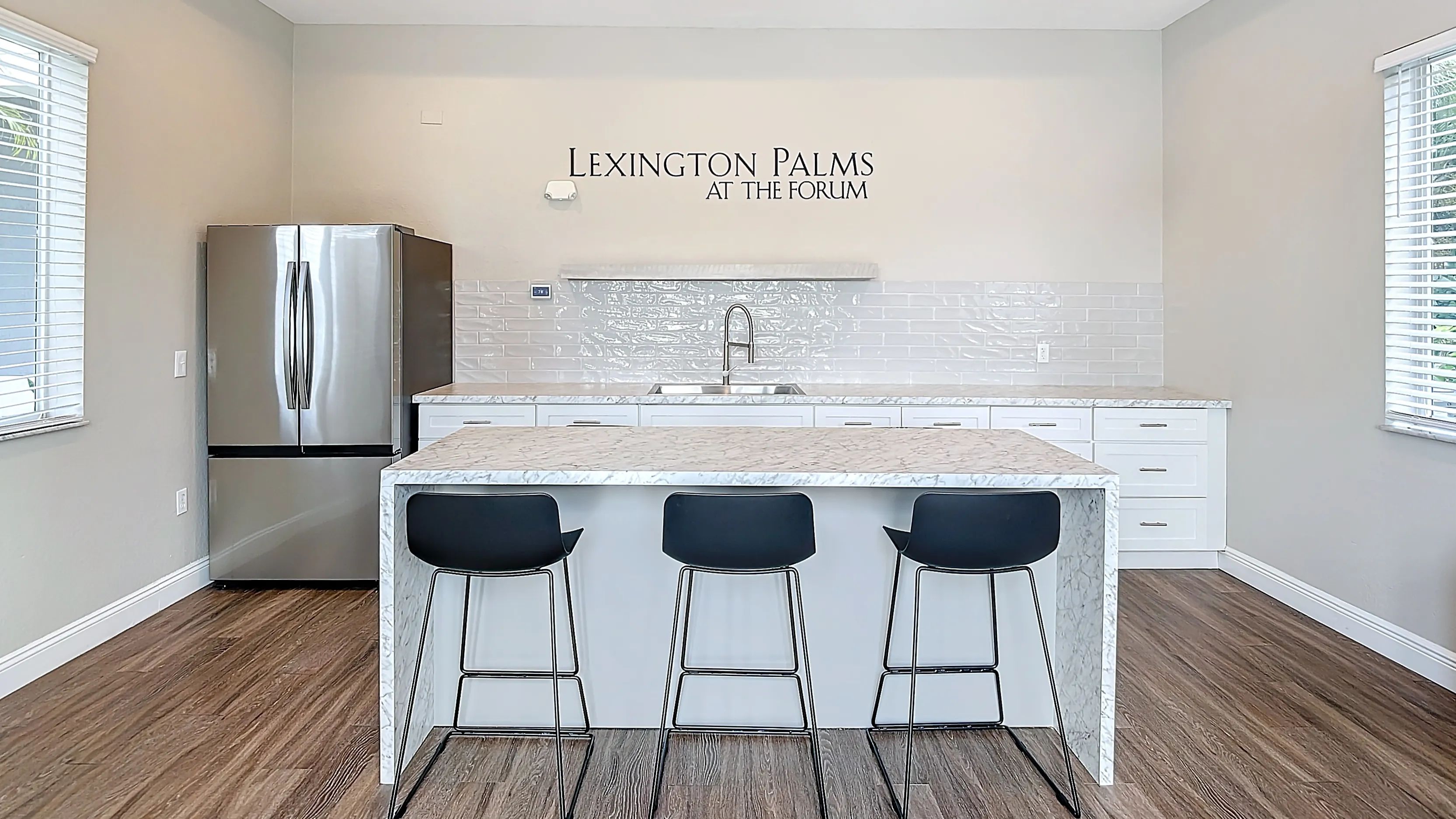 Relax and unwind in the stylish Cabana Room featuring a marble kitchen island, stainless steel appliances, and cozy seating areas.