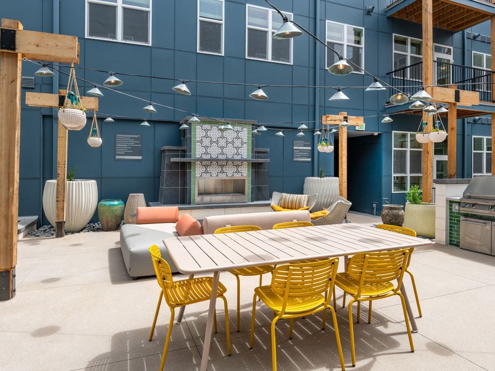 Pool courtyard with grills, dining area, and lounge seating