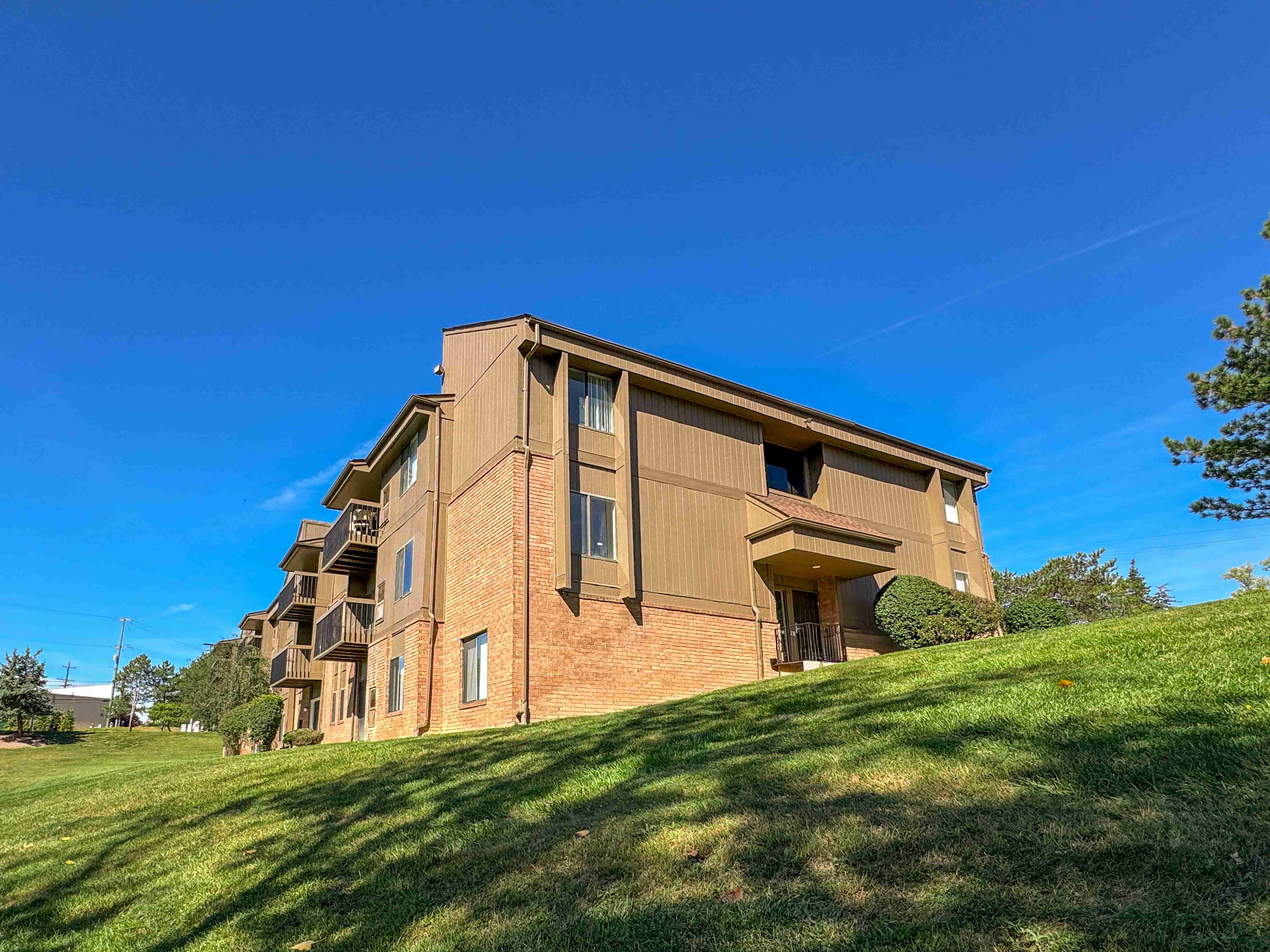 Expansive Green Space Apartment Building Exterior at Franklin River Apartments, Southfield, MI