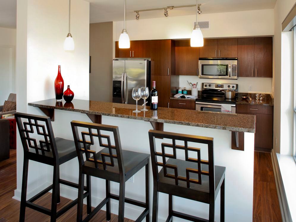 Classic Package I kitchen with brown speckled granite countertops, espresso cabinetry, stainless steel appliances, and hard surface flooring