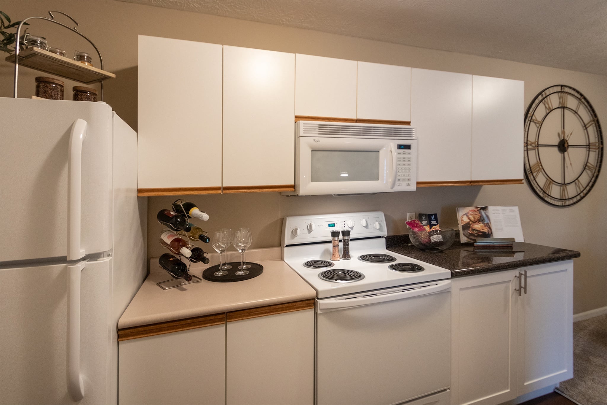 Our model Liberty kitchen features both upgraded cabinetry with dark countertops and classic cabinetry with light countertops.