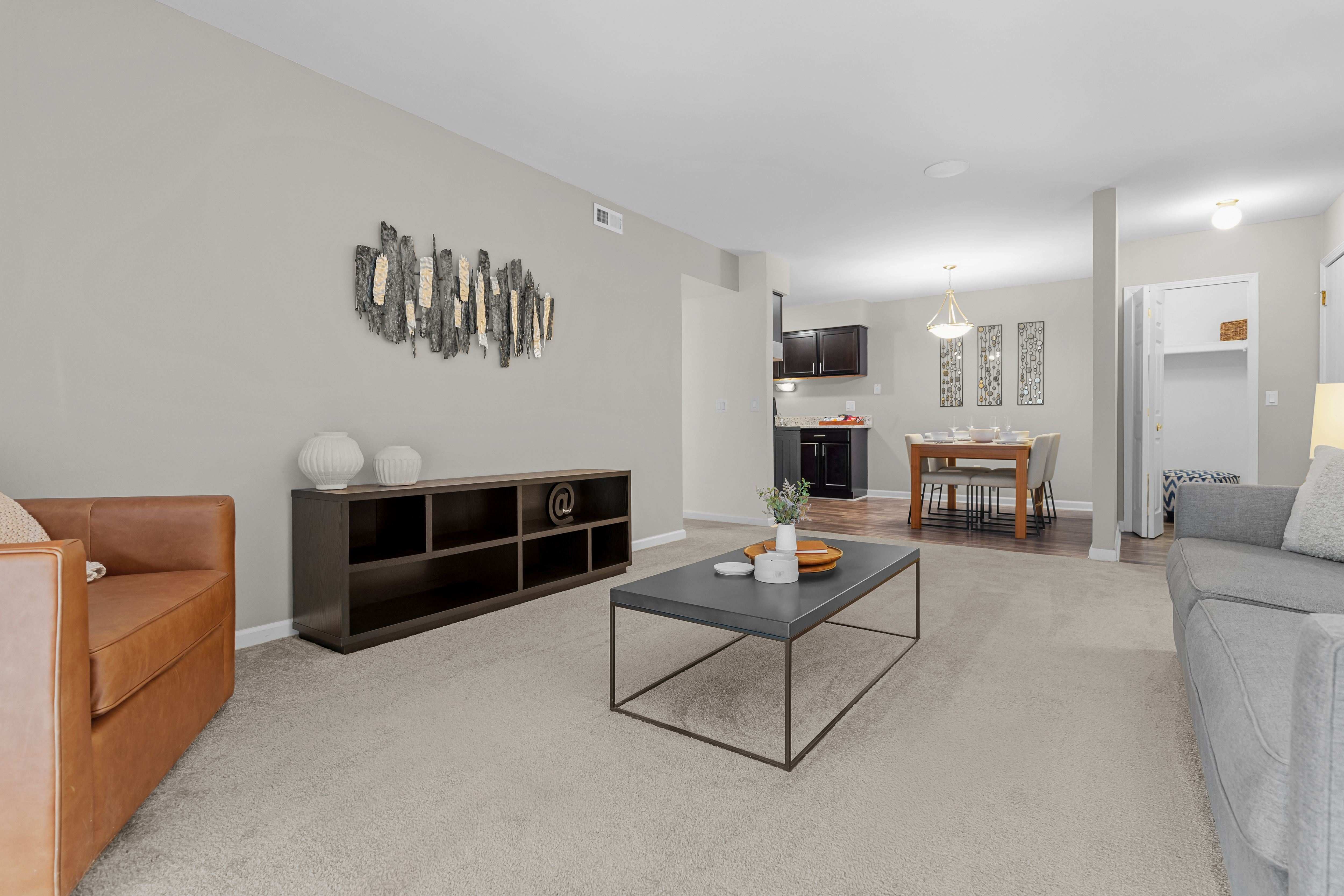 Open concept Living-Dining Area with natural lighting at Lakeside Village Apartments Clinton Township, MI