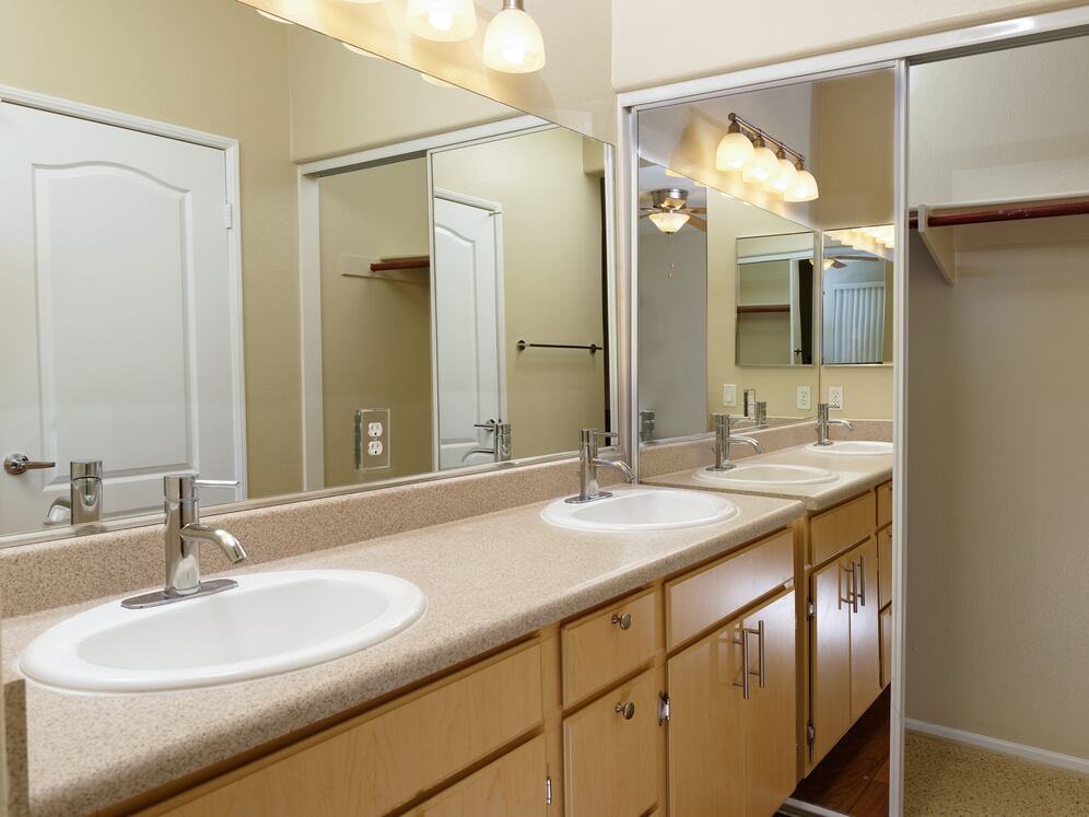 Bath with laminate countertops, oak cabinetry, and hard surface flooring
