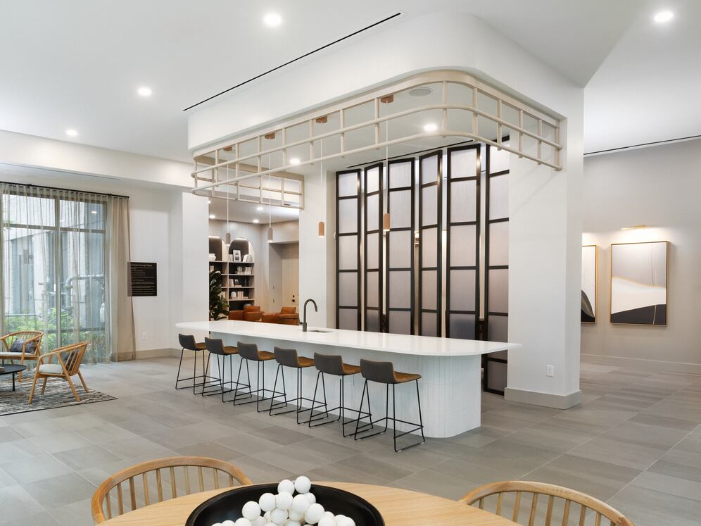 Building 700 resident lounge with kitchenette and multiple seating areas