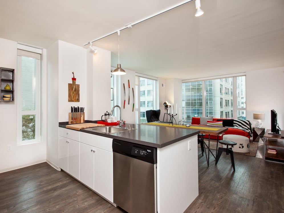 Kitchen with white cabinetry, stainless steel appliances, chrome countertops and hard surface flooring