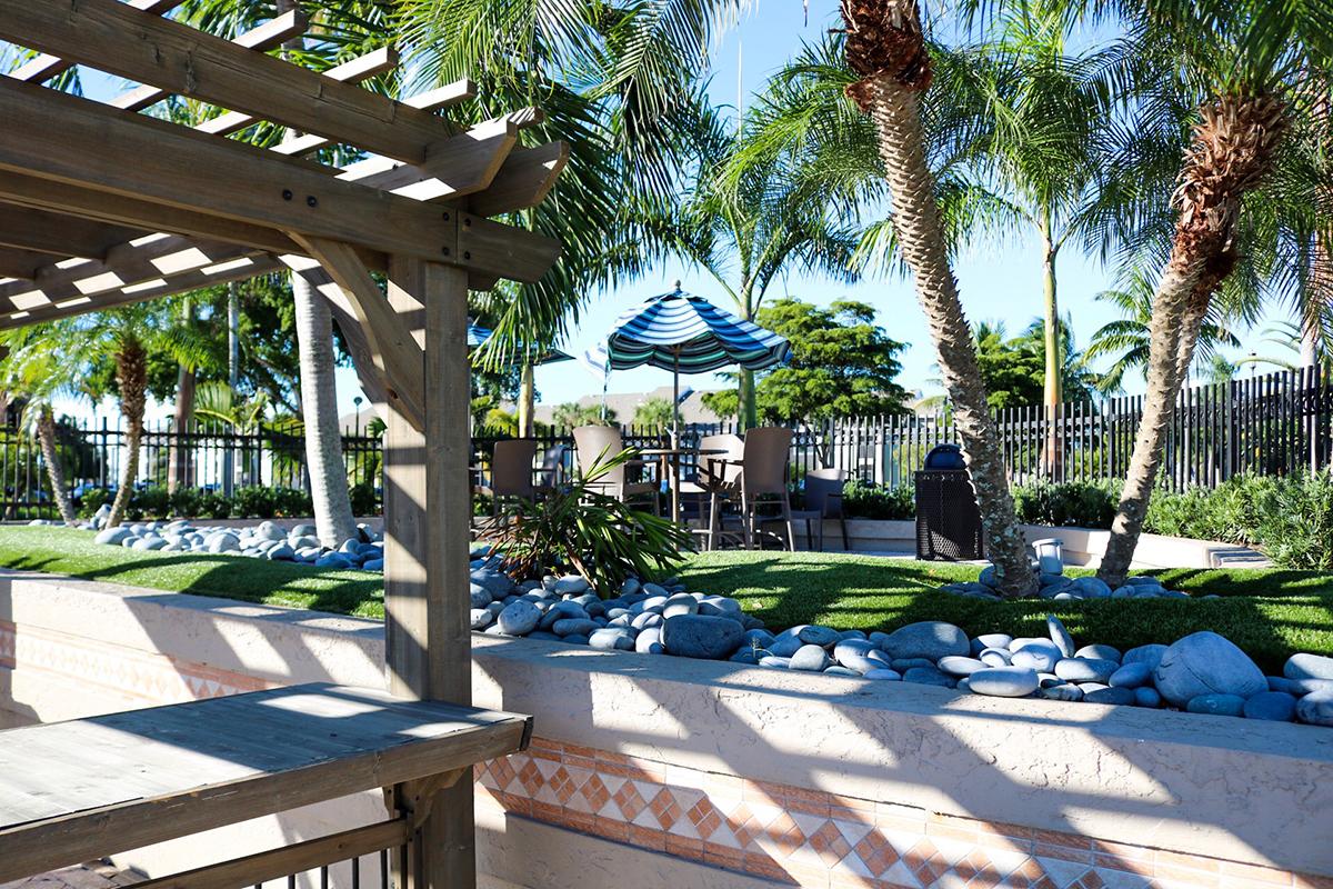 Umbrella seating areas located next to the pool. 