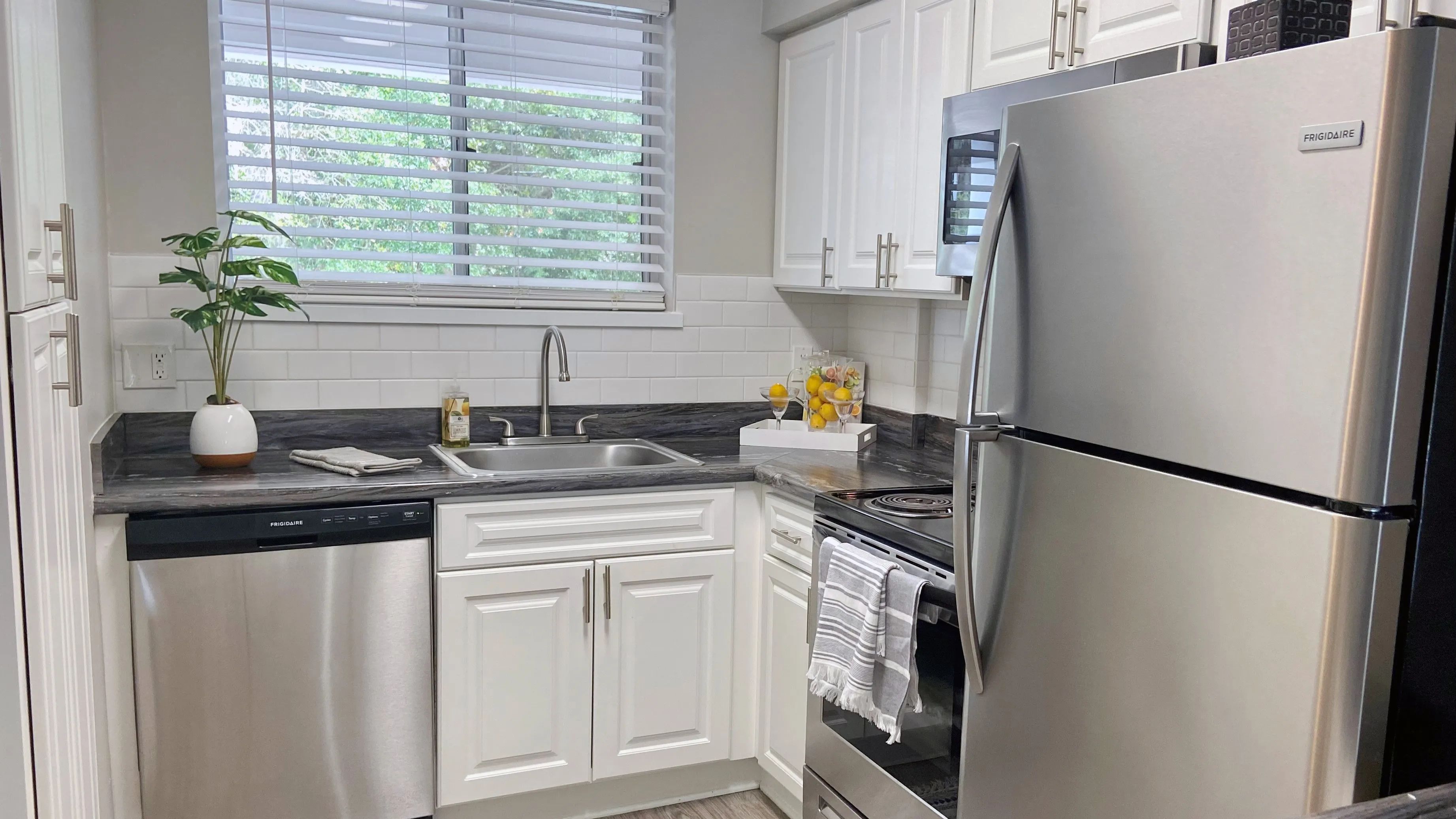 Be inspired by the culinary brilliance of our kitchens, adorned with a radiant subway tile backsplash, gleaming stainless-steel appliances, and ample white cabinetry for maximized storage.