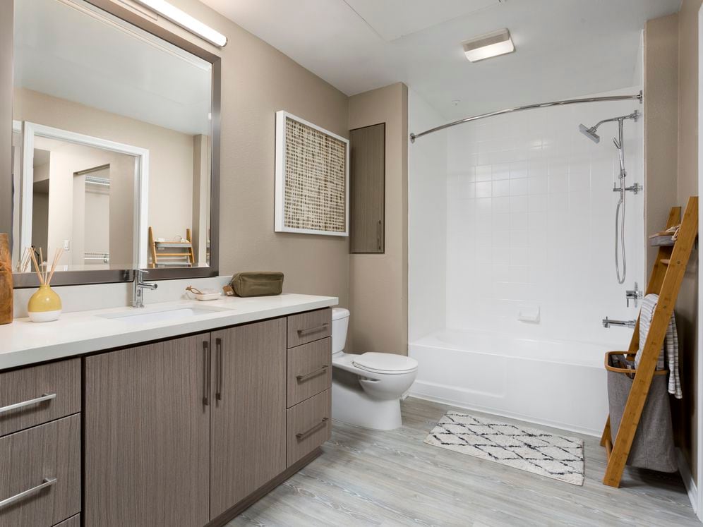 Design Scheme II bath with quartz countertops, new cabinets, and hard surface plank flooring