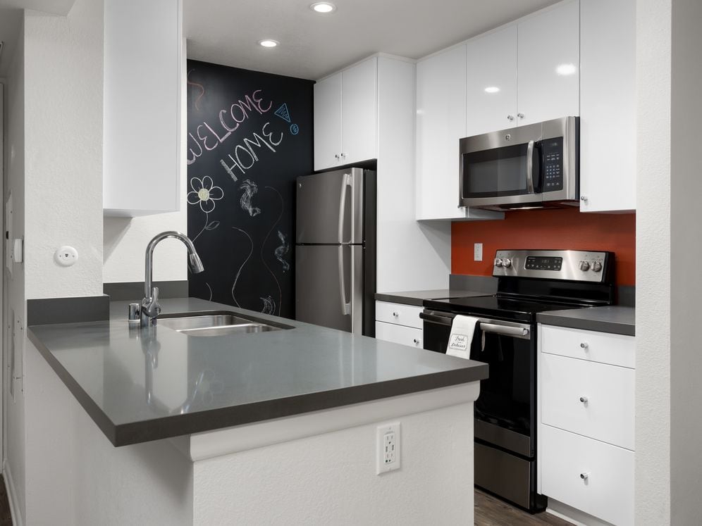 Design Package II Kitchen with quartz countertops stainless steel appliances and hard surface flooring