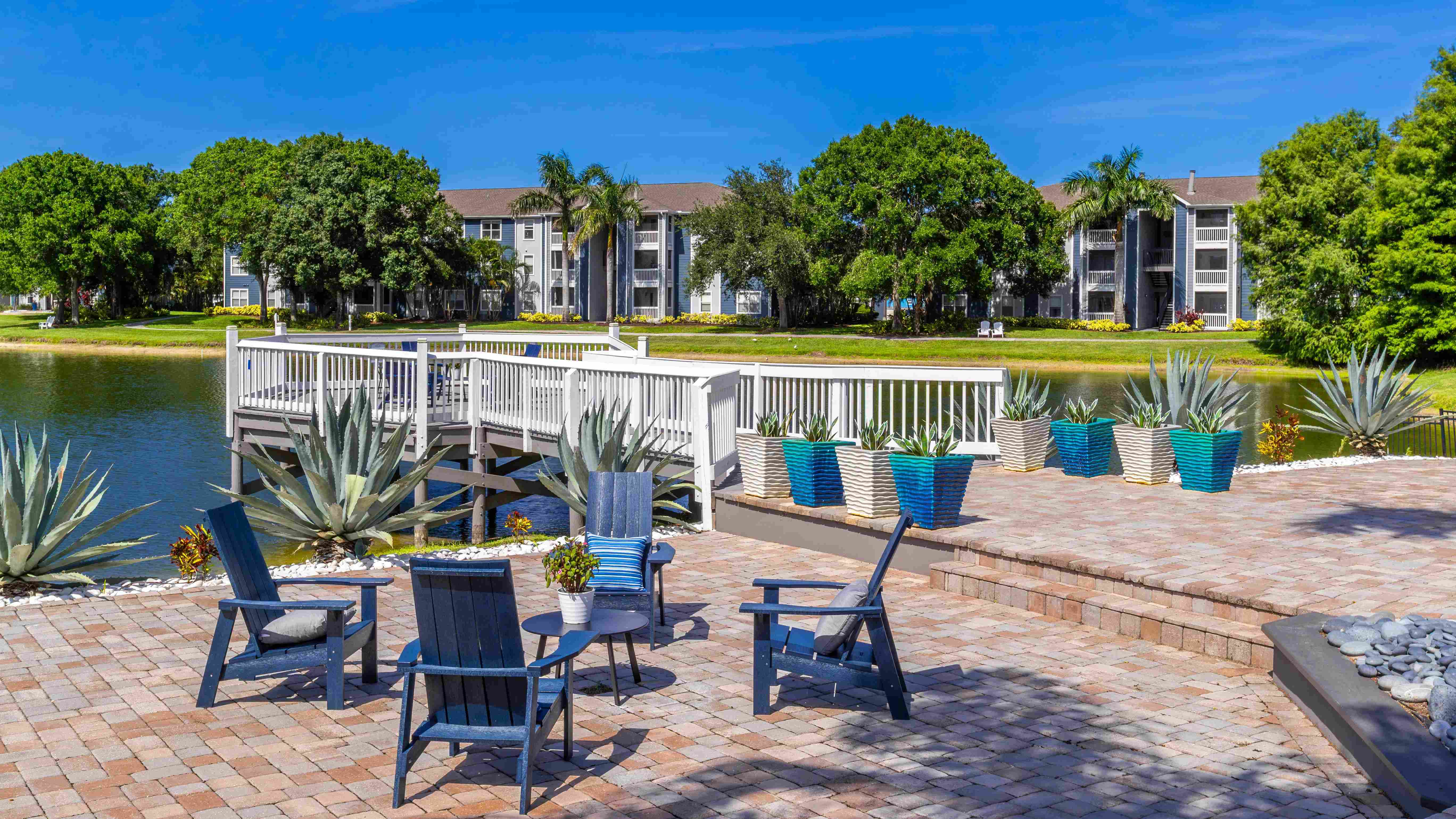 Gather with neighbors on our inviting waterfront patio and dock, complete with comfortable seating and lush lake views.