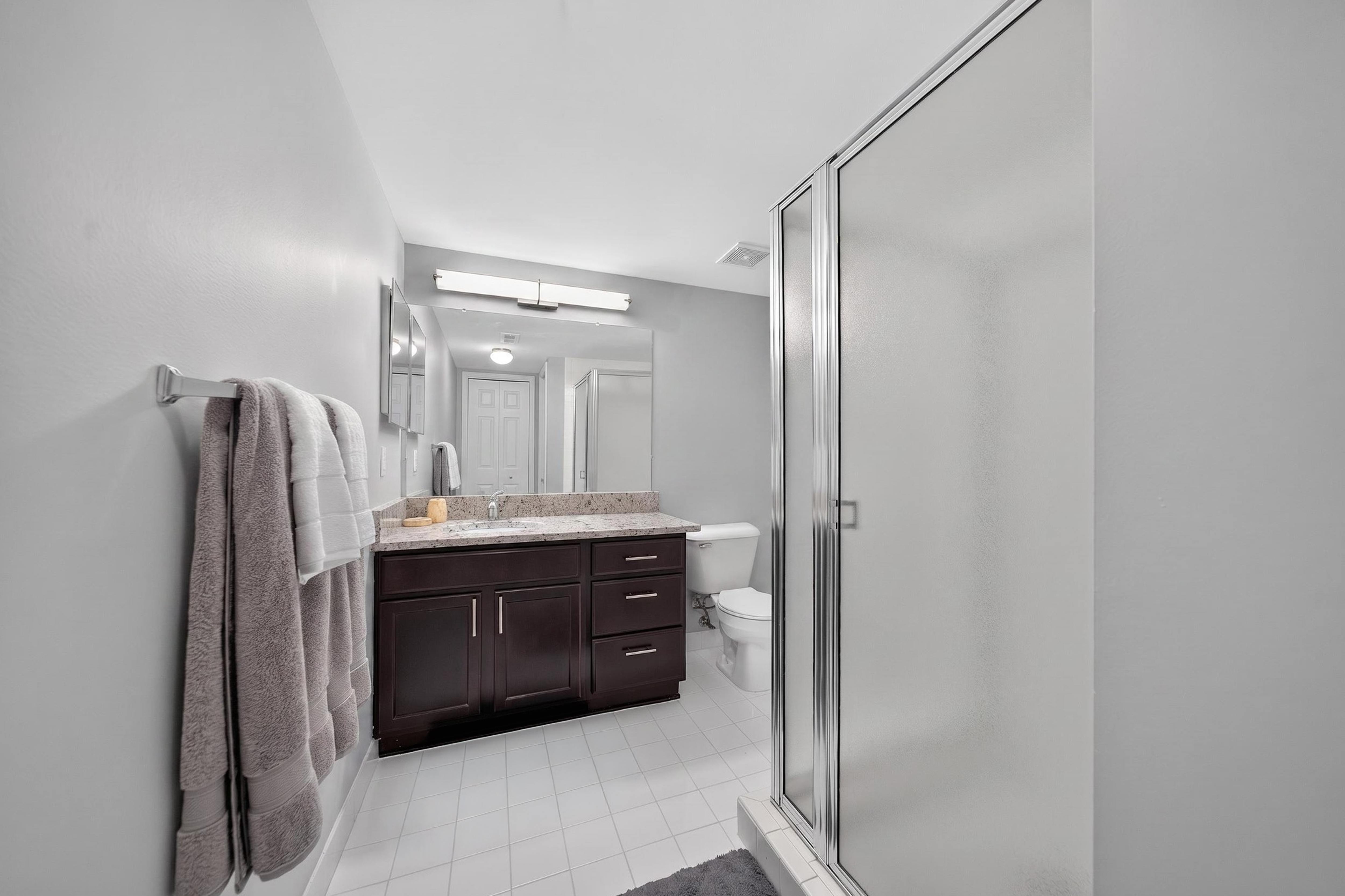 Bathroom with Shower and Ample Storage at Lakeside Village Apartments in Clinton Township, MI