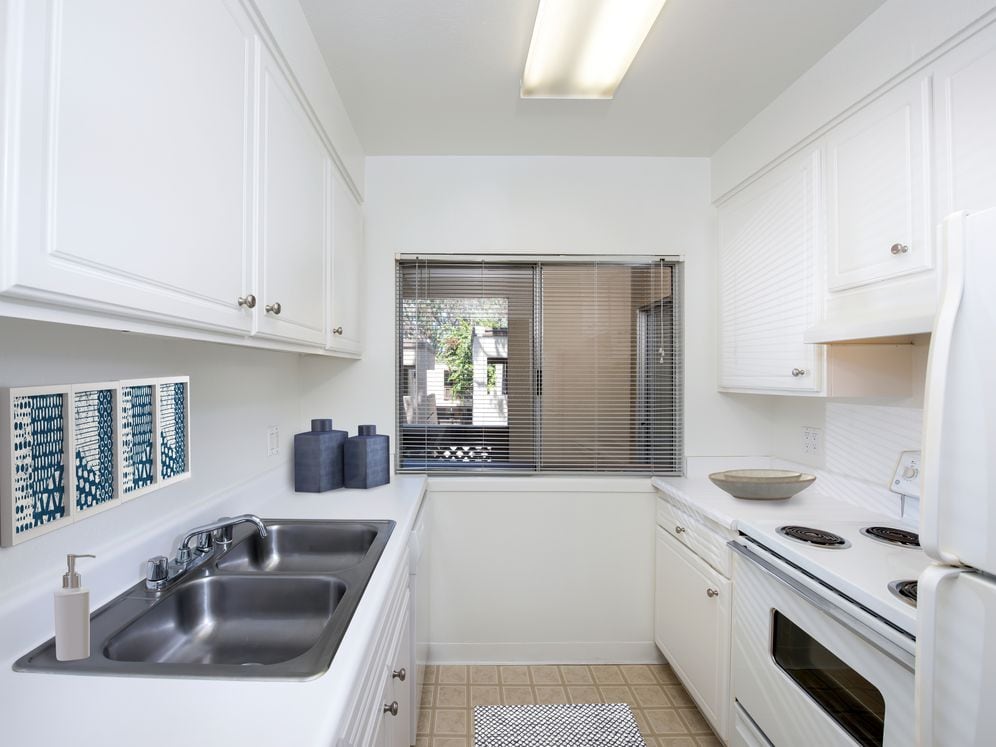Classic kitchen with white cabinetry and white appliances
